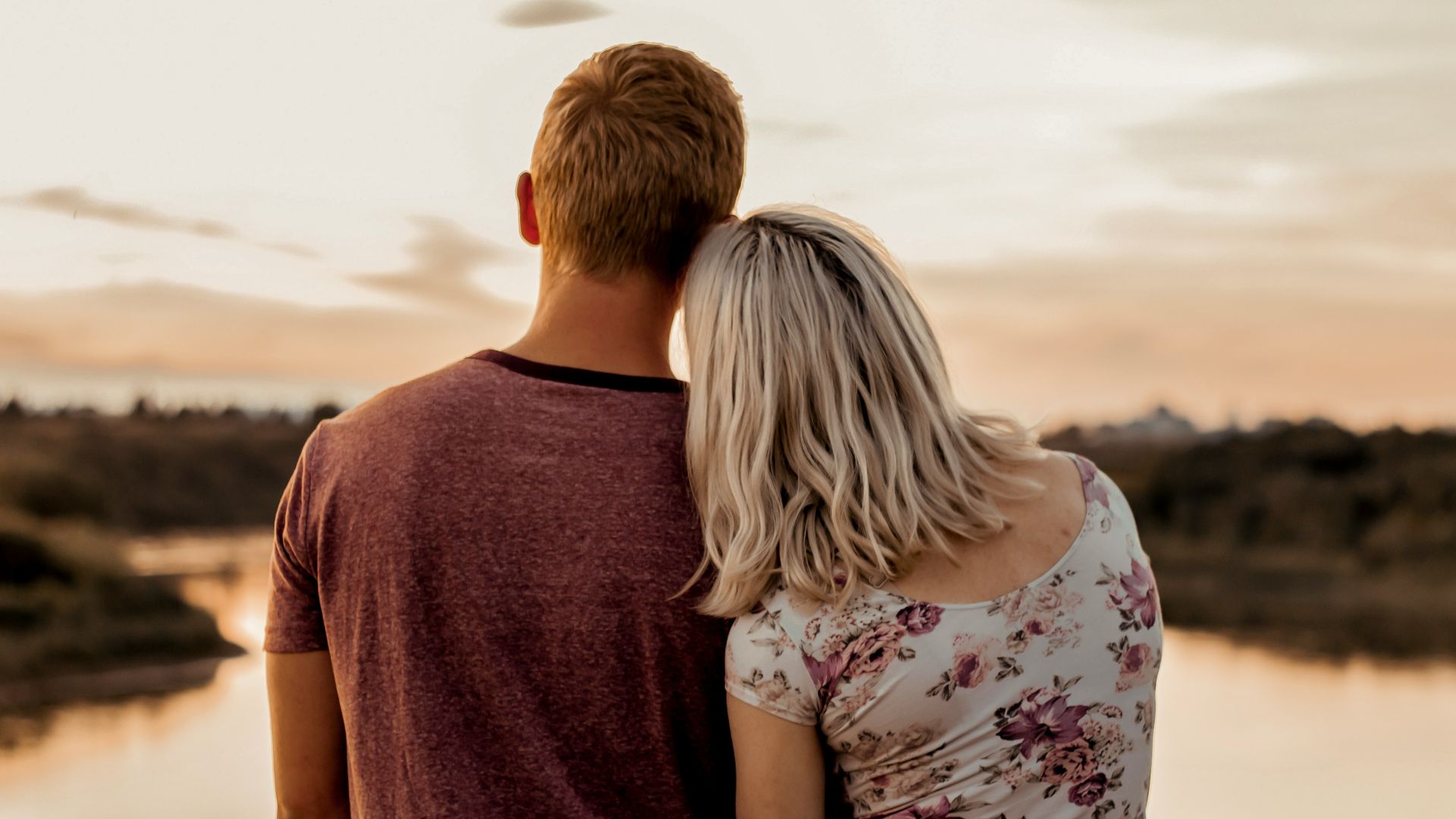 man and woman standing on brown field during daytime