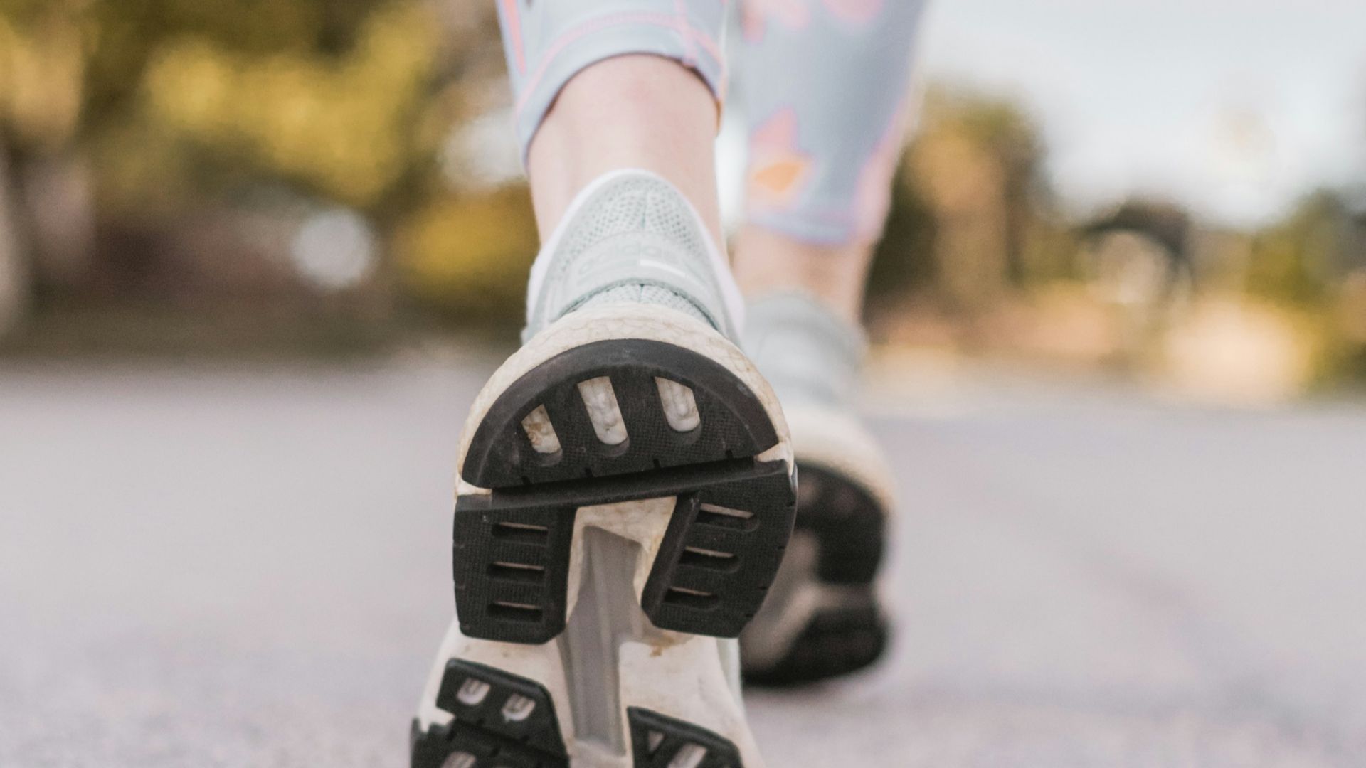 person wearing black and white nike shoes