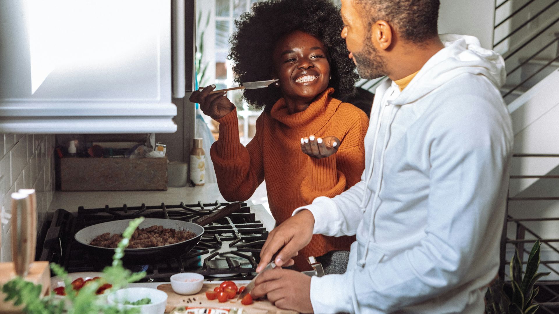 man in white dress shirt holding a woman in brown long sleeve shirt