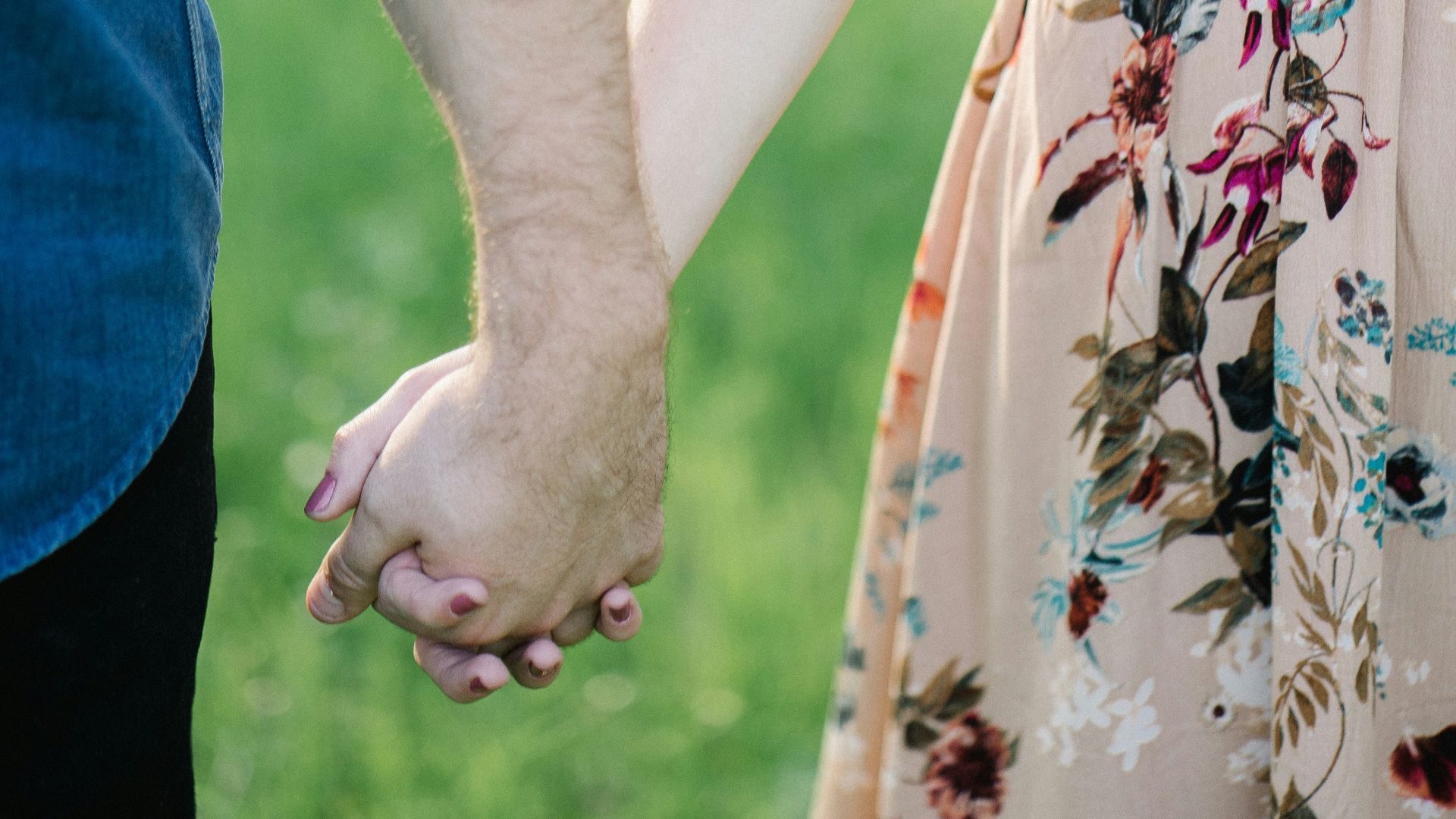 selective focus photography of man and woman holding there hands