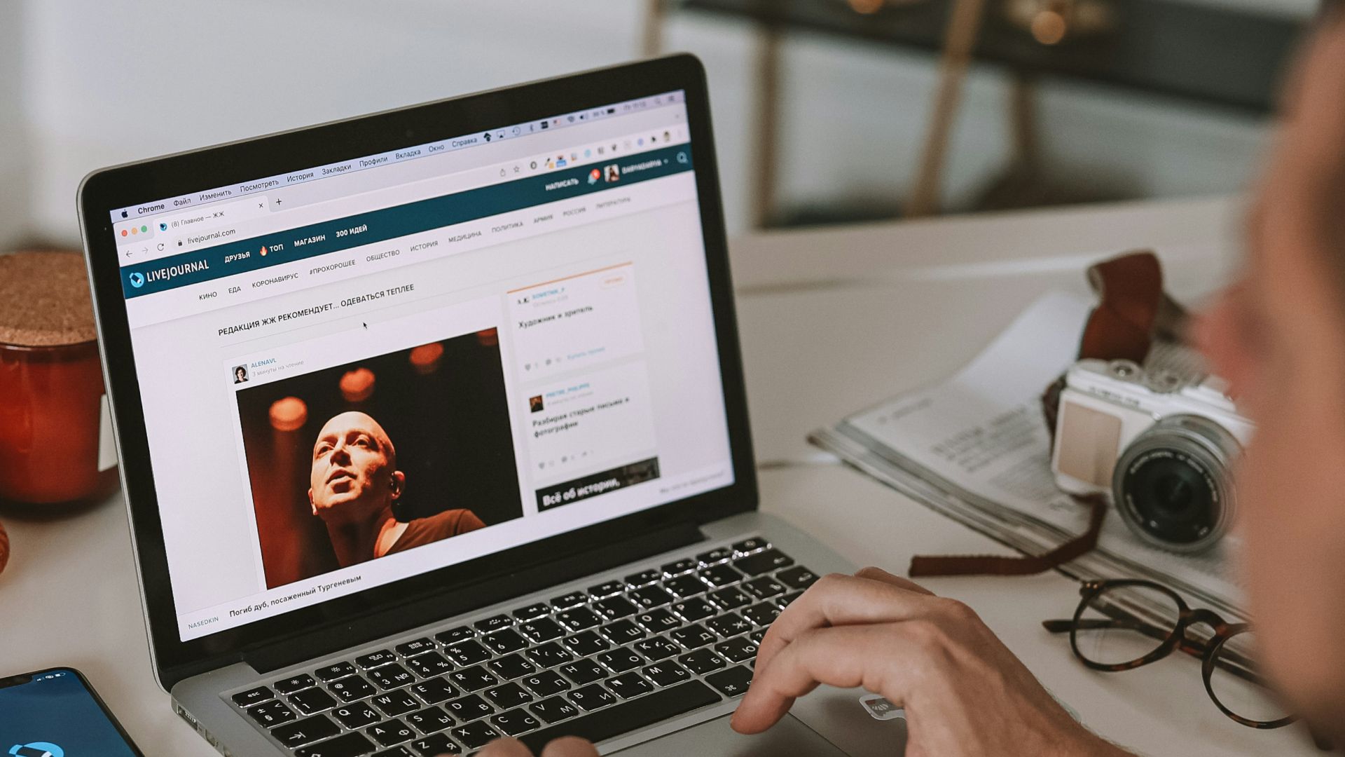 a man sitting at a desk using a laptop computer