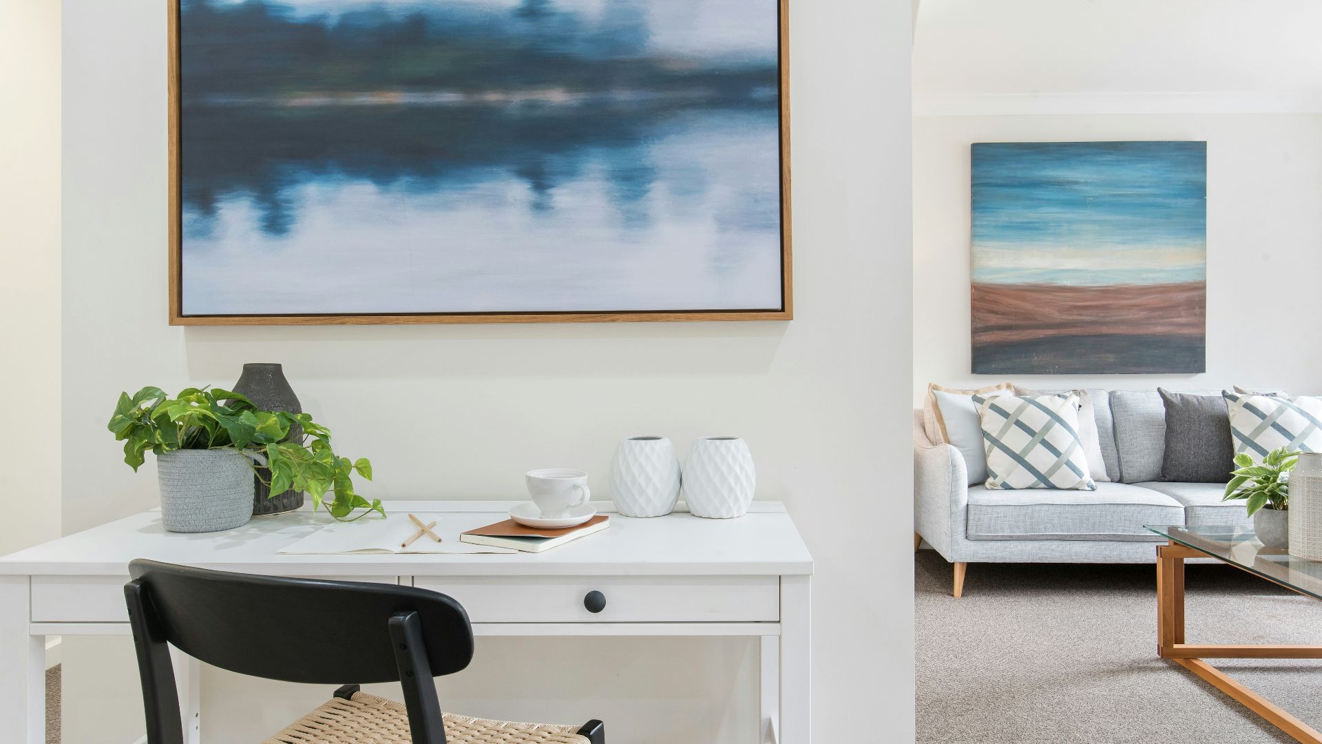 white and black table with chairs near body of water painting
