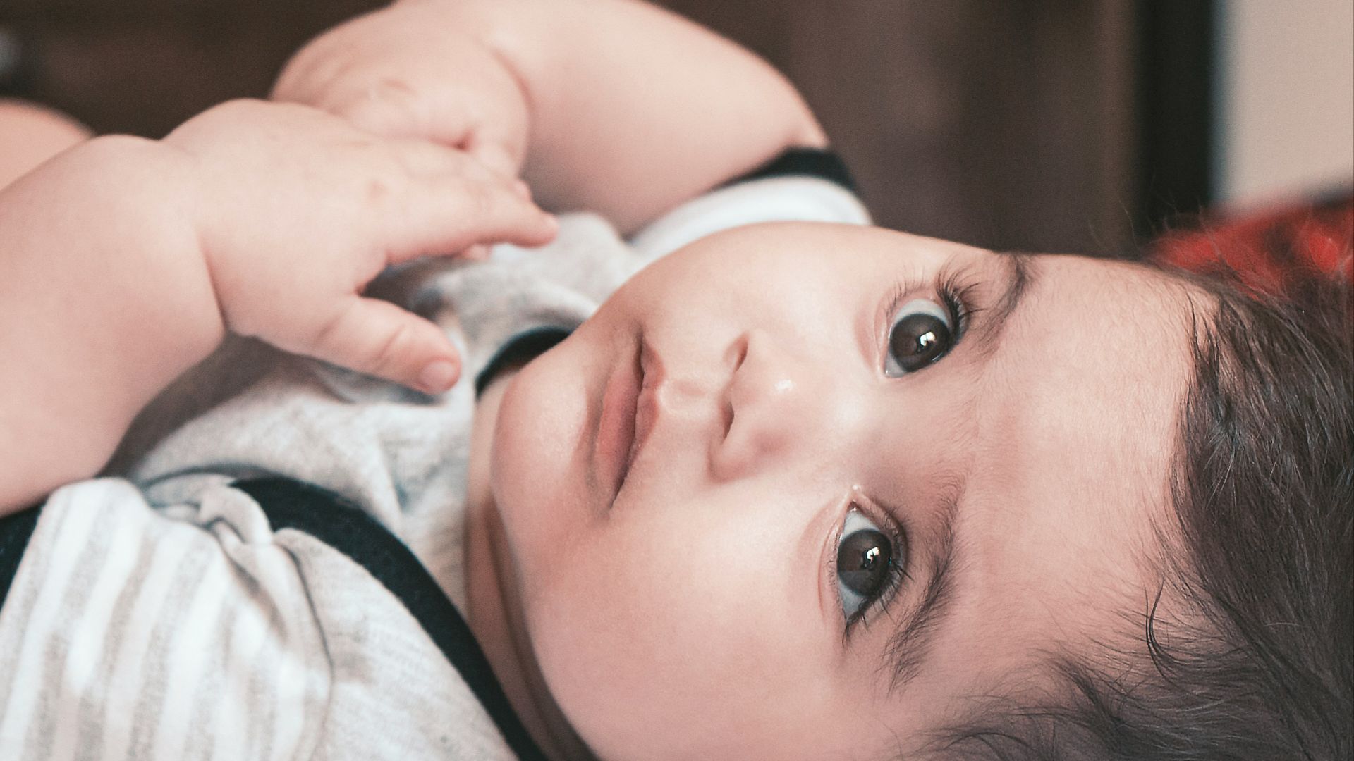 baby in white and pink shirt