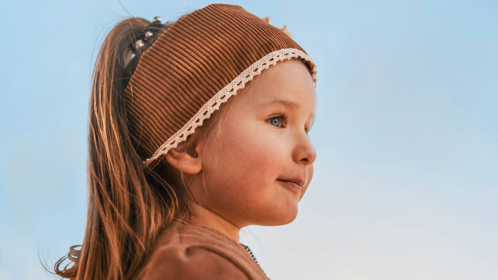girl in brown jacket and black and white plaid skirt