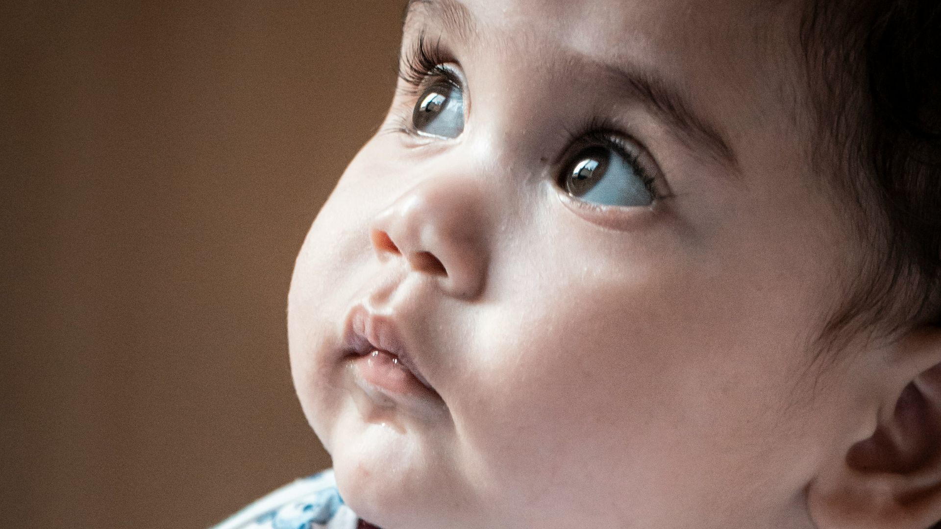 child in white red and blue crew neck shirt