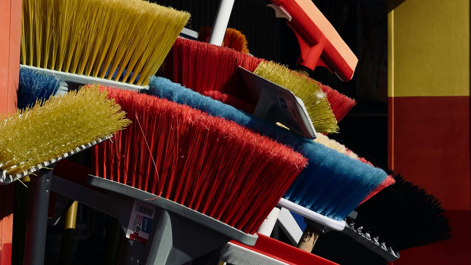 a bunch of brooms that are outside of a building