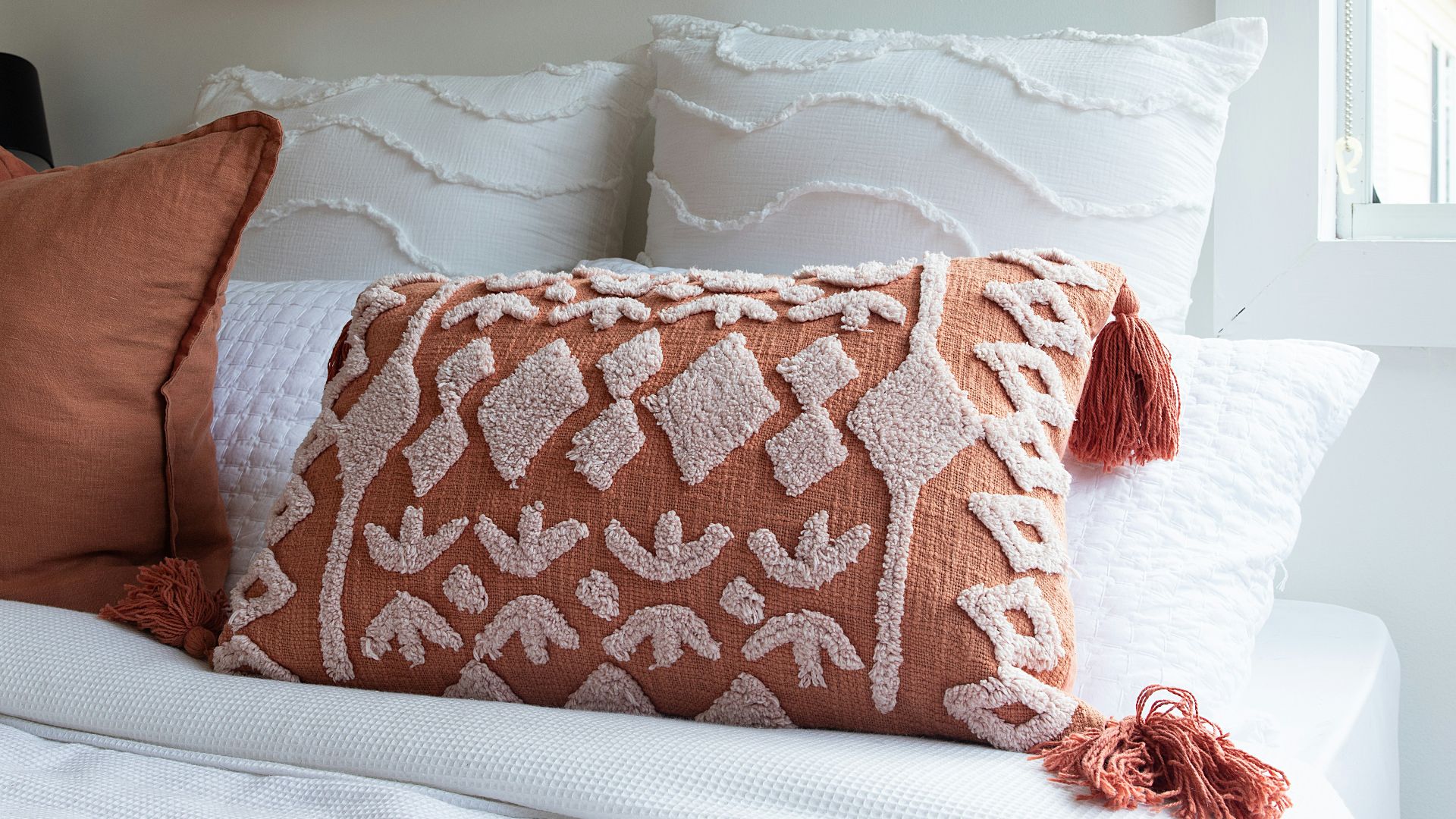 a close up of a pillow on a bed