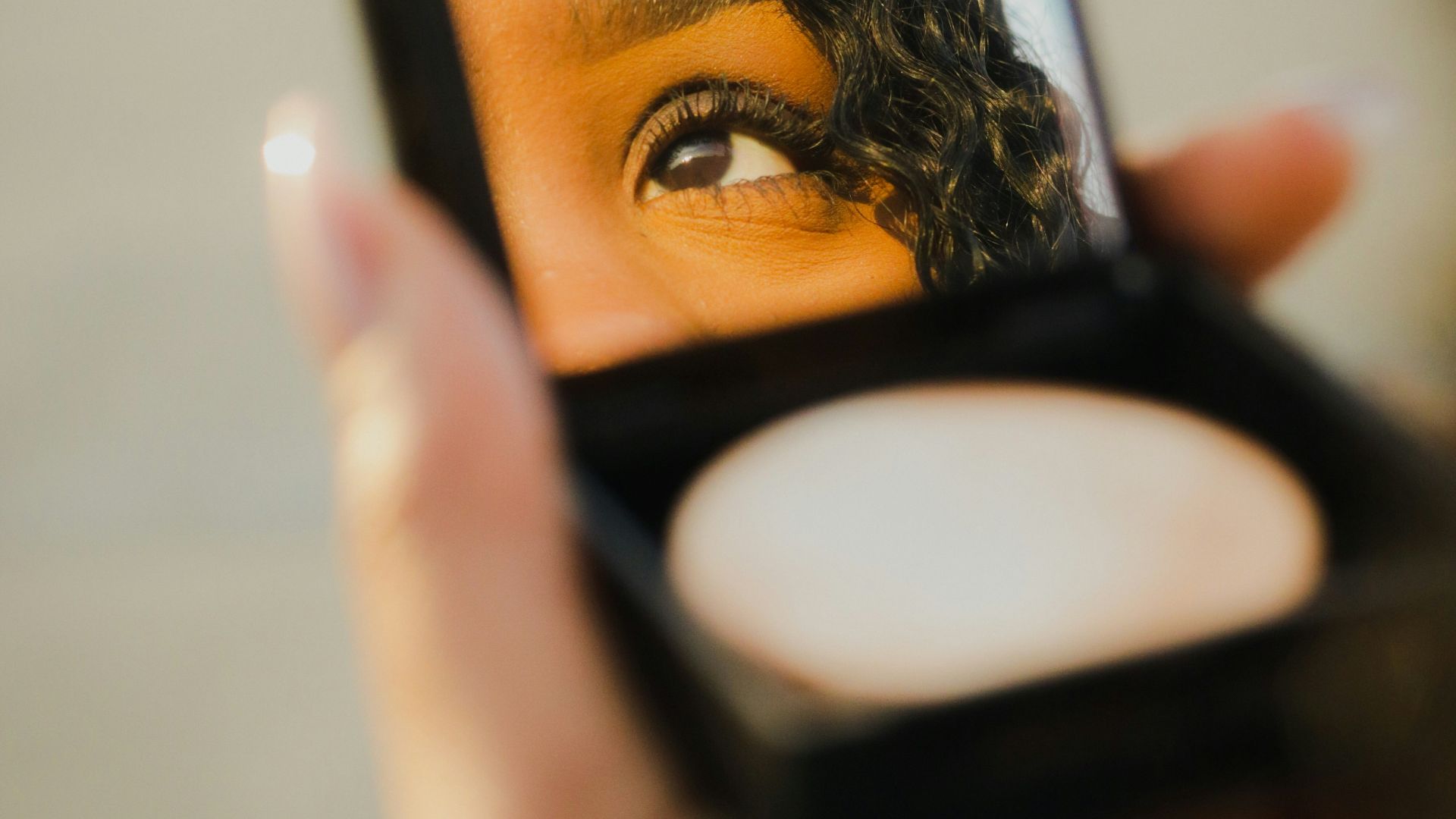 a woman holding a compact compact compact compact compact compact compact compact compact compact compact compact