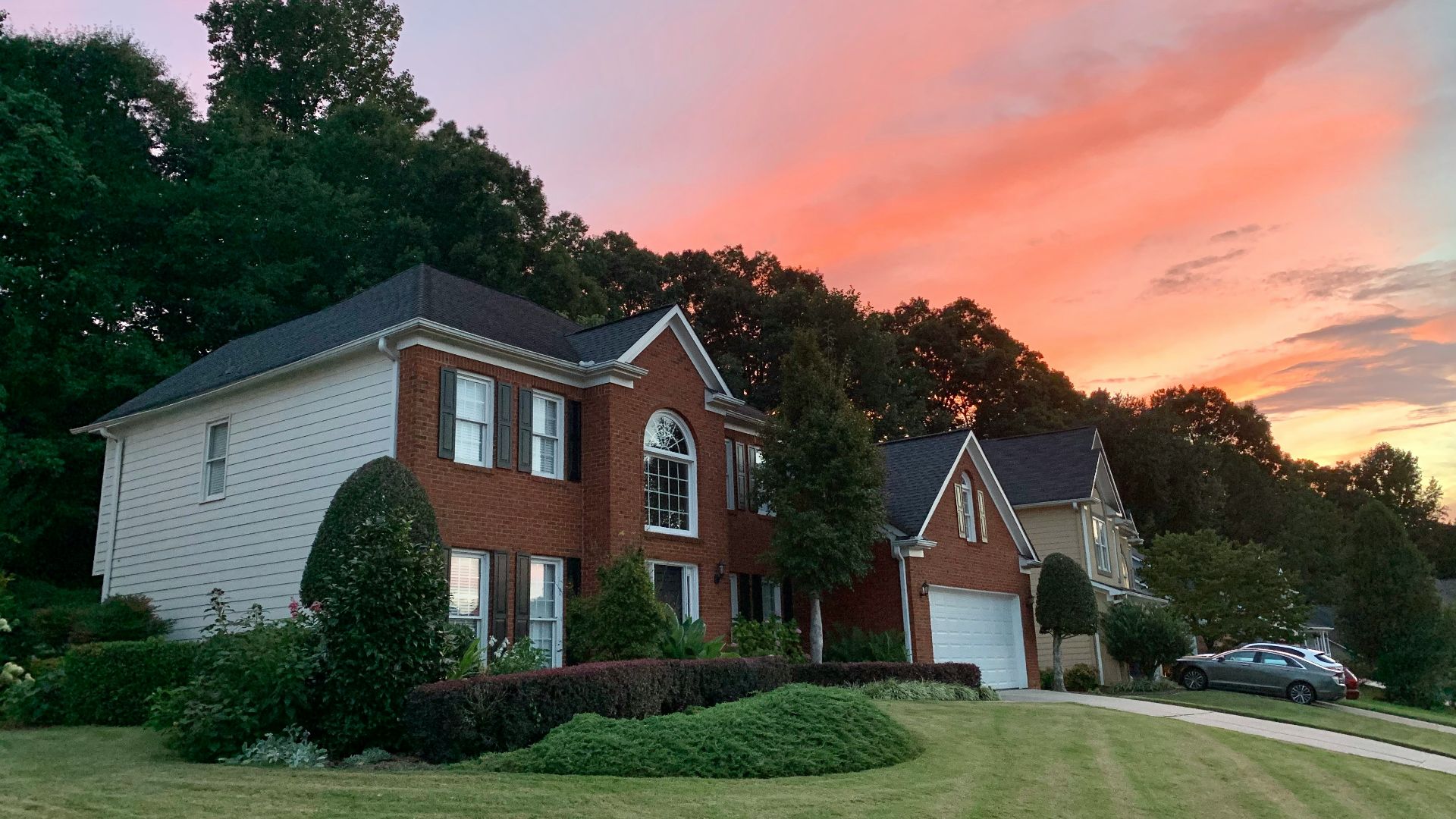 white and brown house near green grass field during daytime