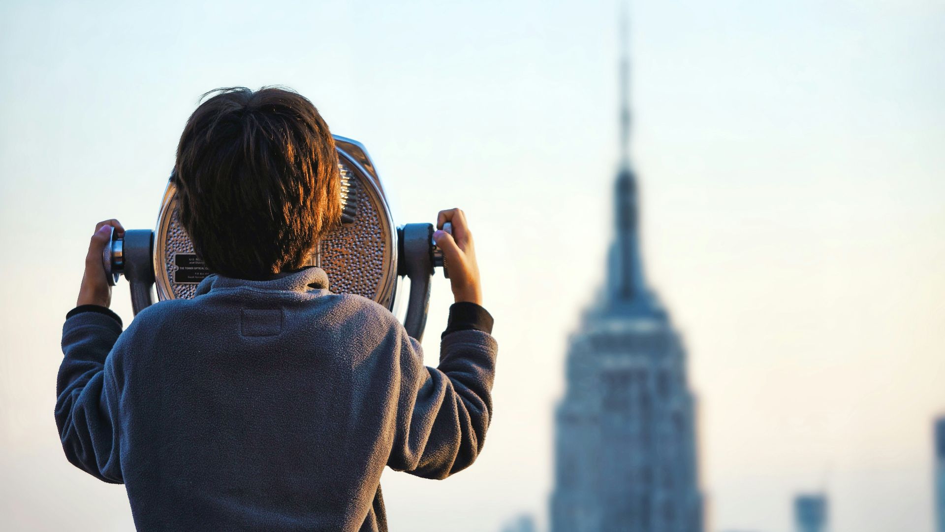 child looking at Empire State building through tower viewer