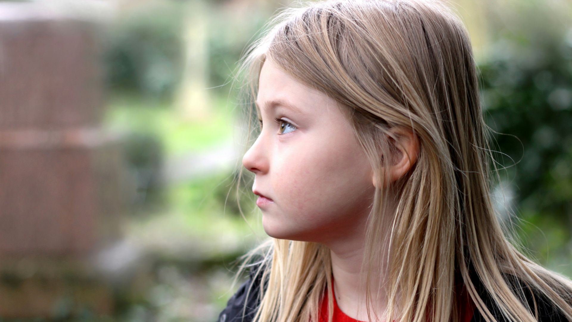 girl in red crew neck shirt and black jacket