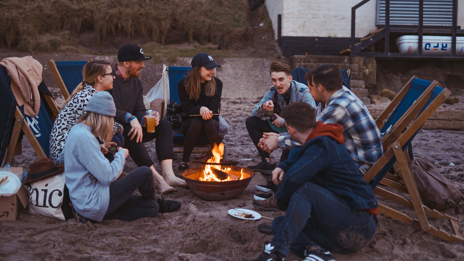 group of people sitting on front firepit