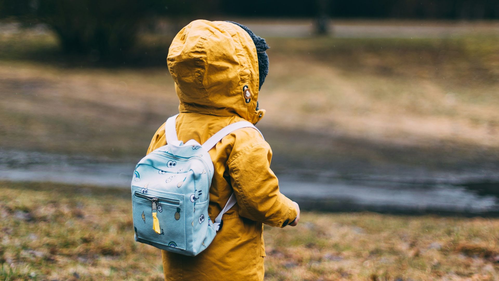 shallow focus photo of toddler walking near river