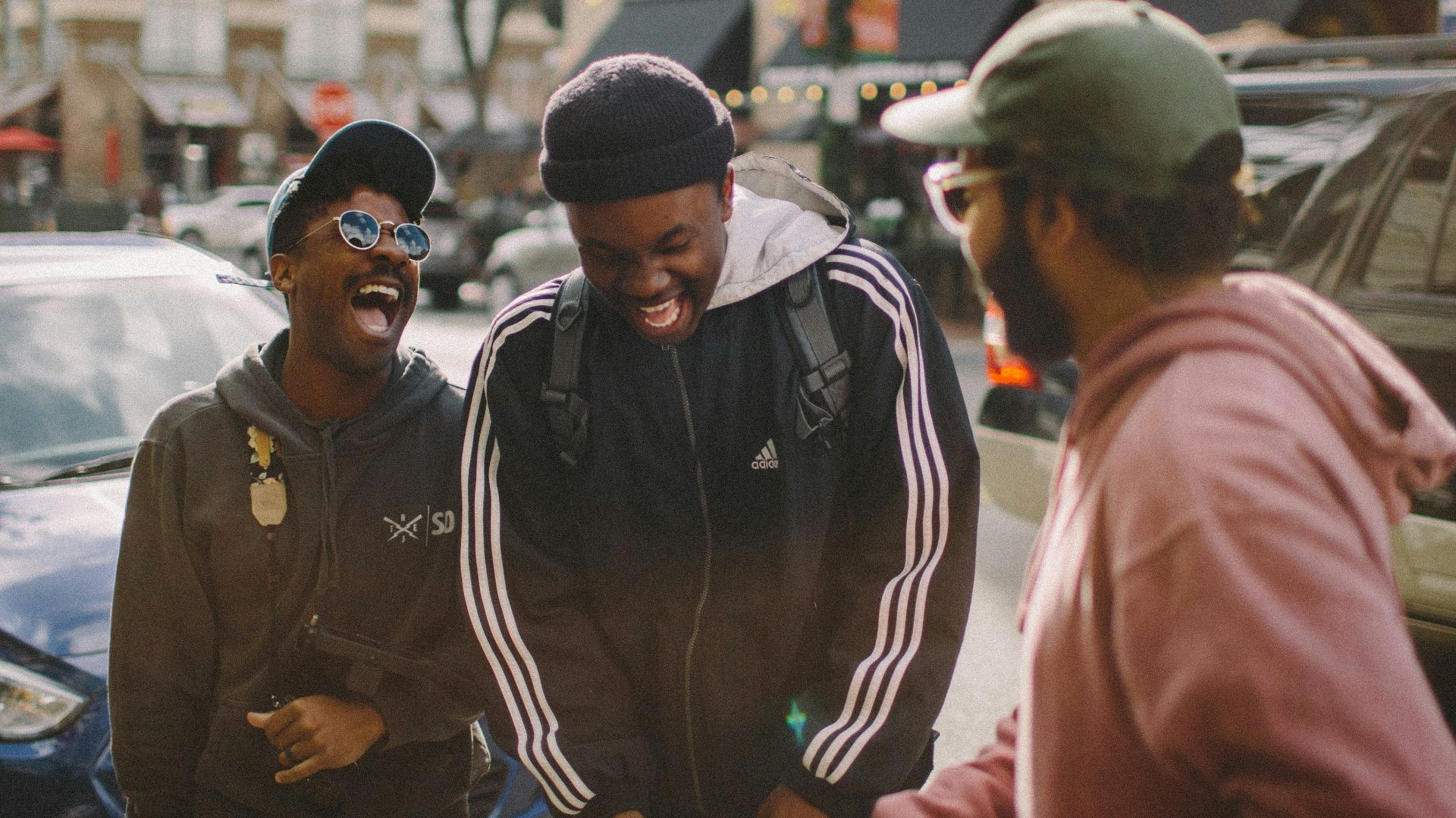 three men in jacket laughing at each other
