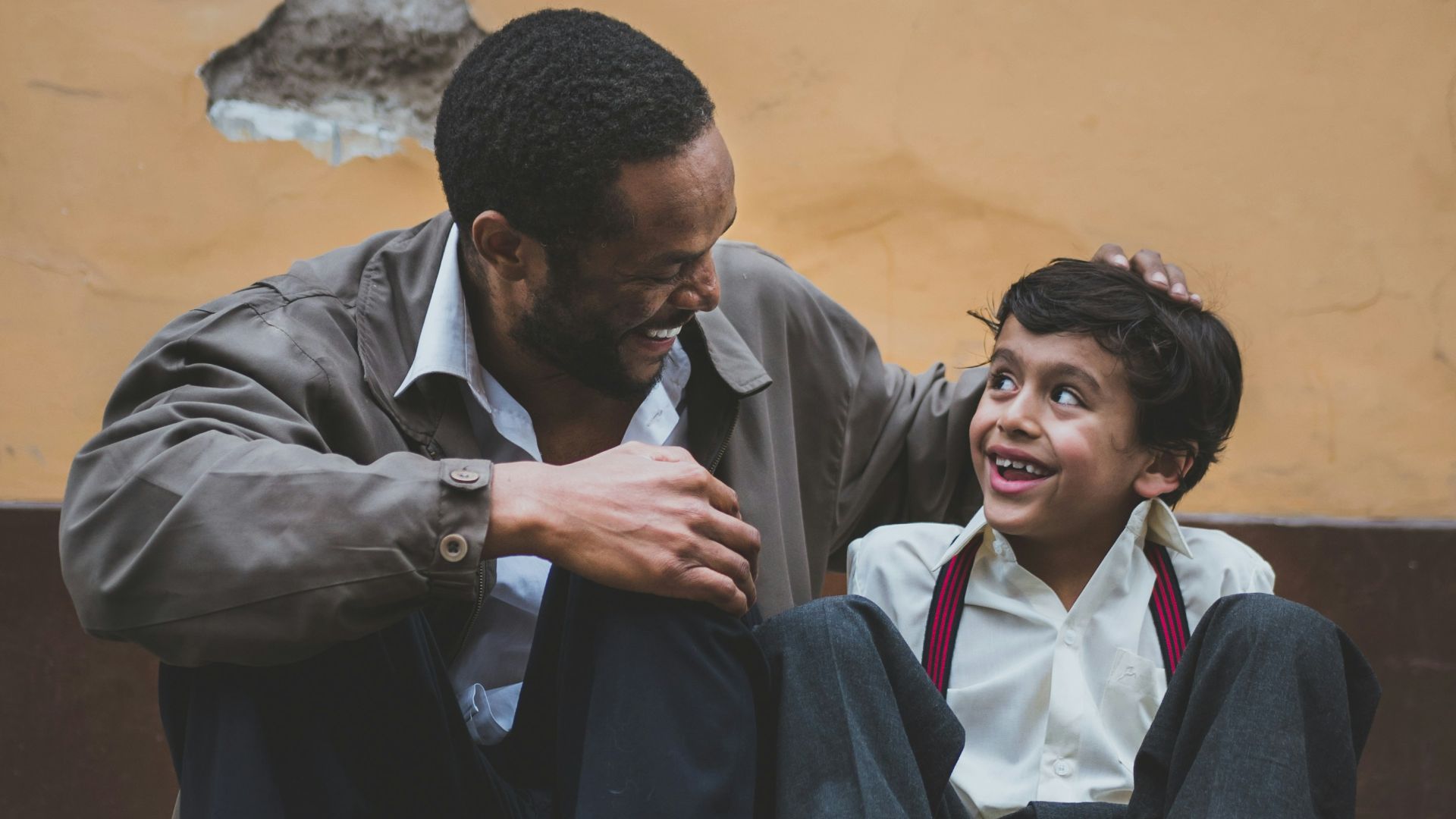 man holding boy's head