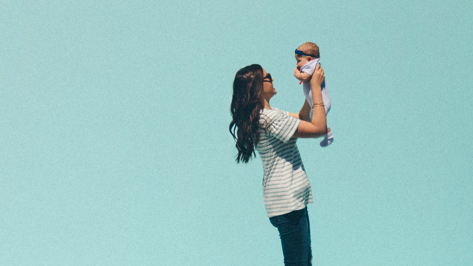 woman carrying baby while walking