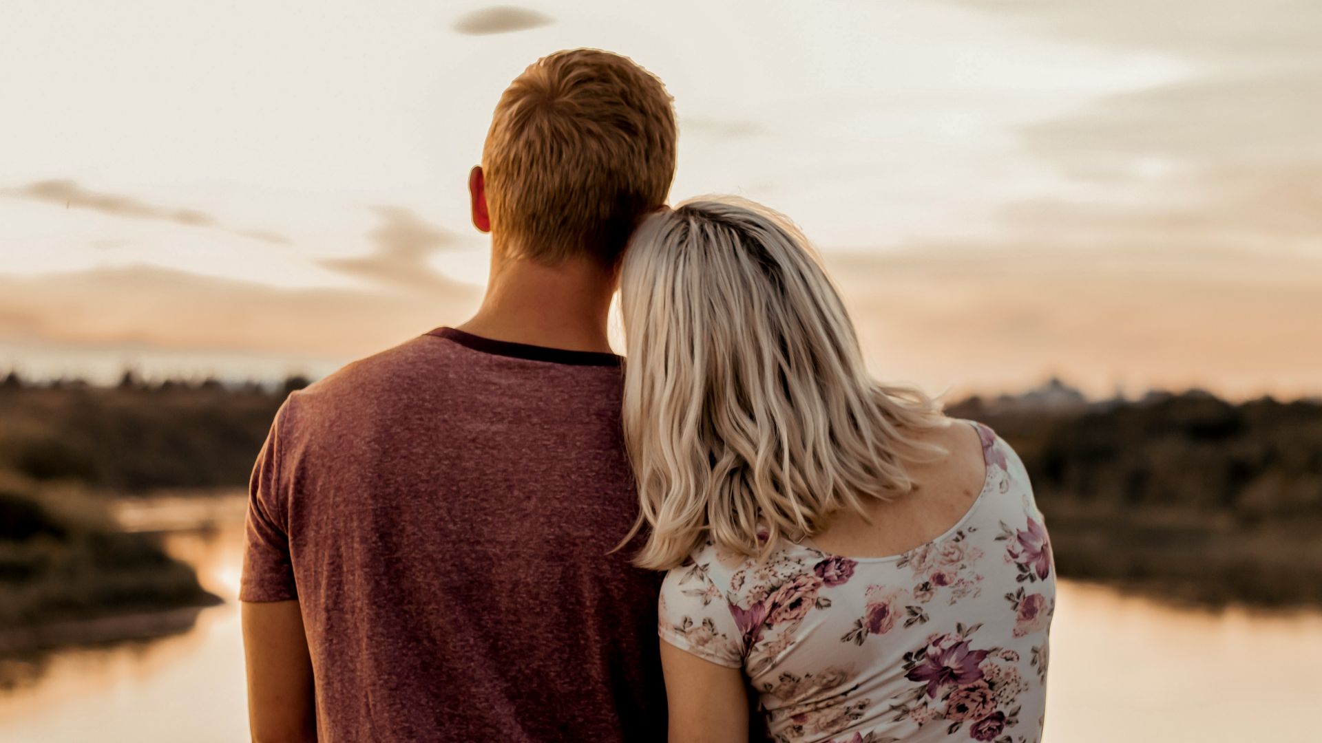 man and woman standing on brown field during daytime
