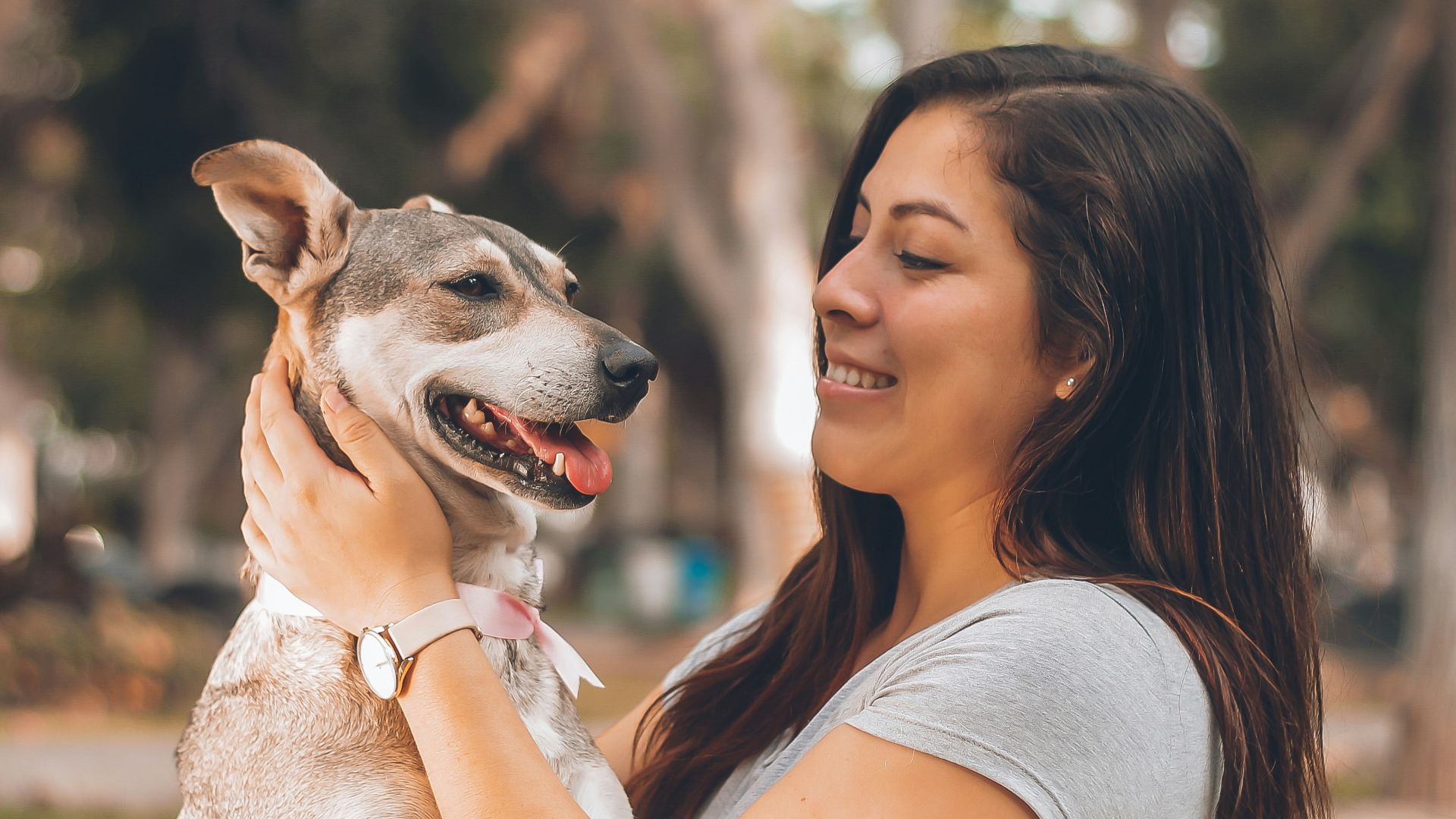 woman playing with dog