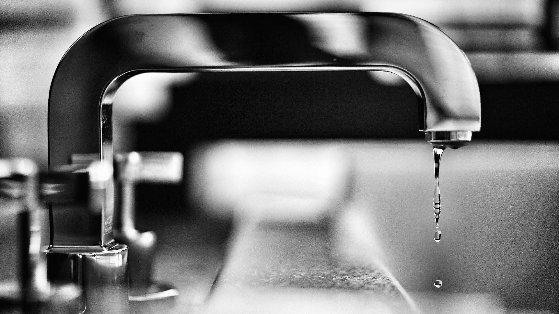 grayscale photography of faucet