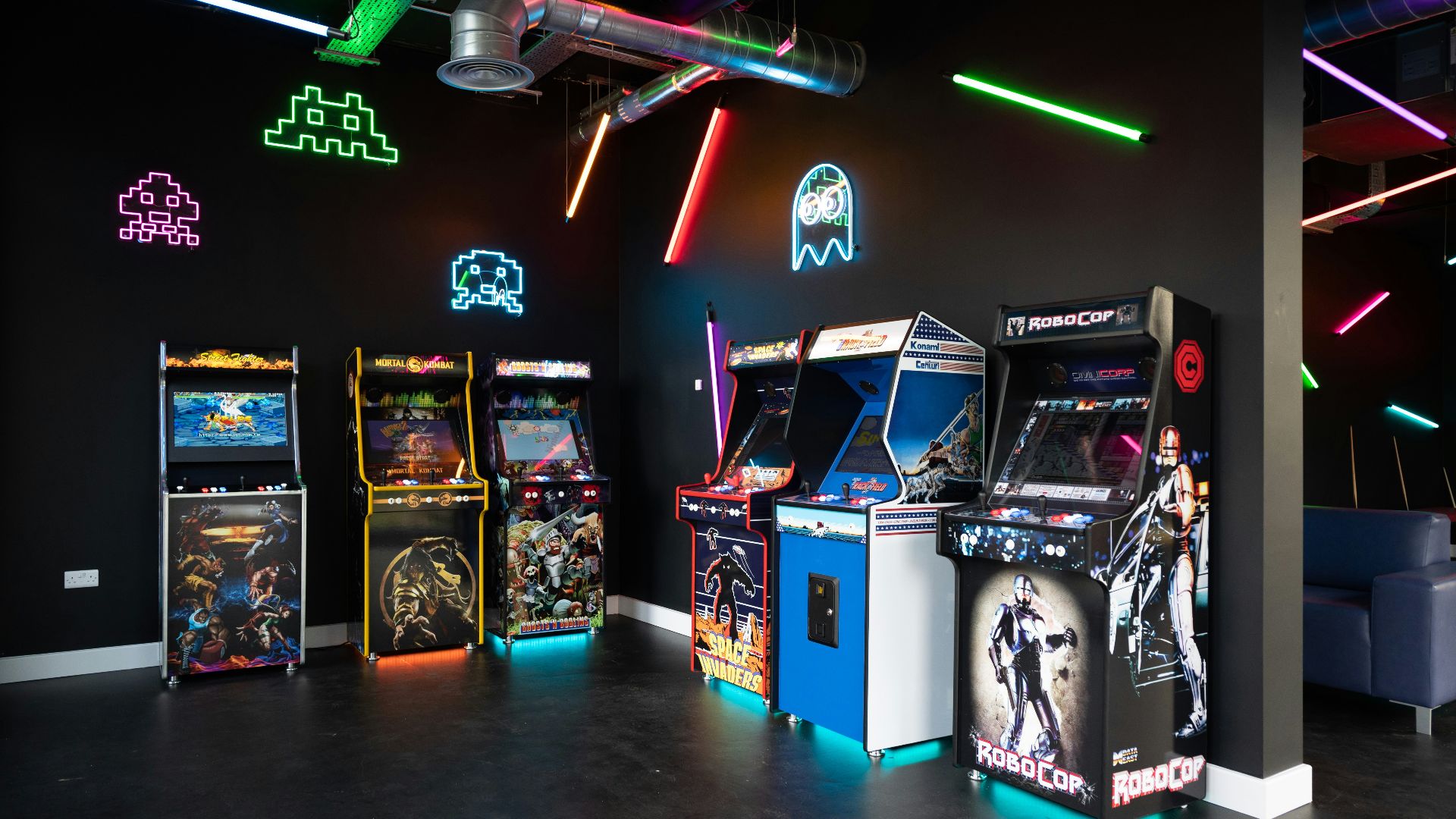 a room filled with arcade machines and neon lights