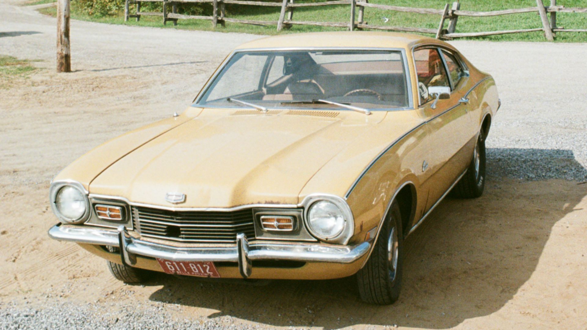 brown and white vintage car parked on gray asphalt road during daytime