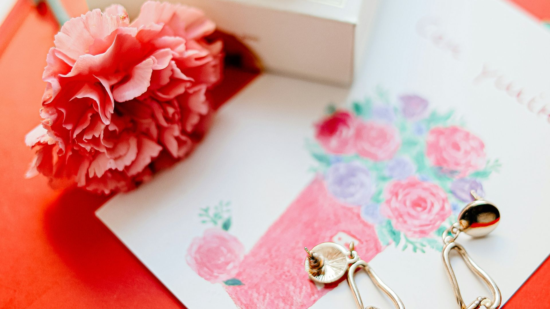 pink and white rose on white and red greeting card