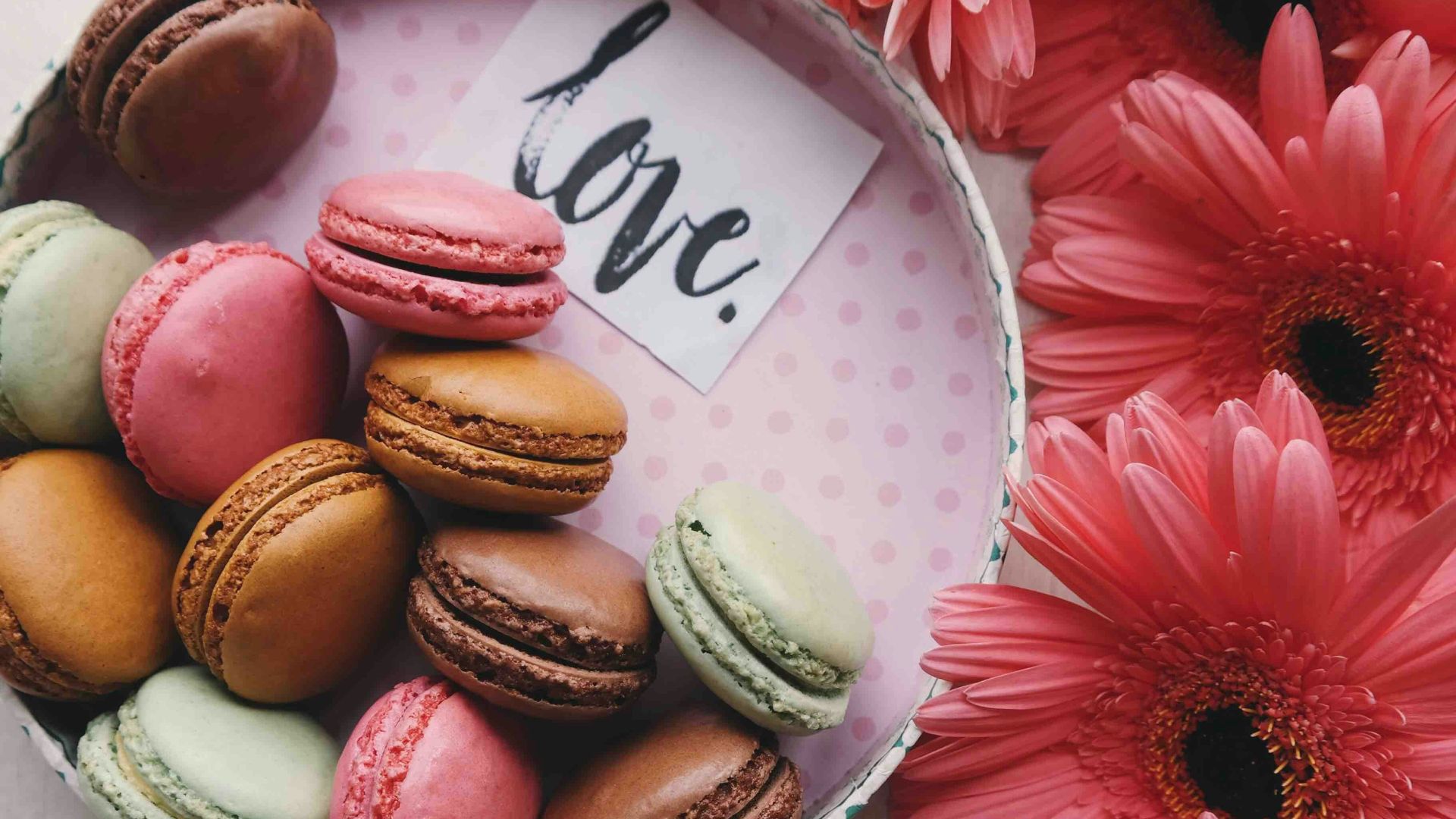 macaroons on a tray with the word 'love'