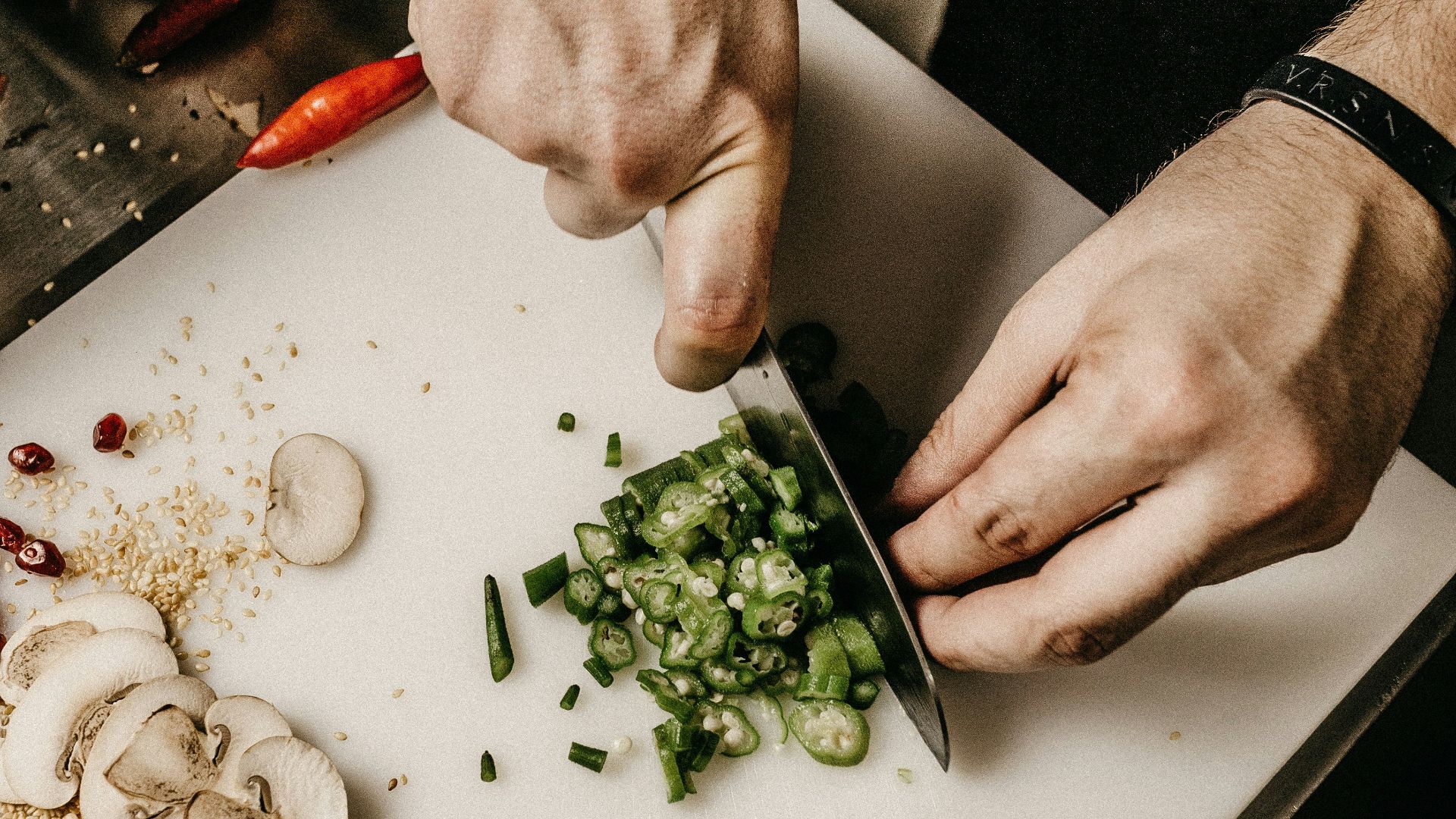 person slicing vegetable