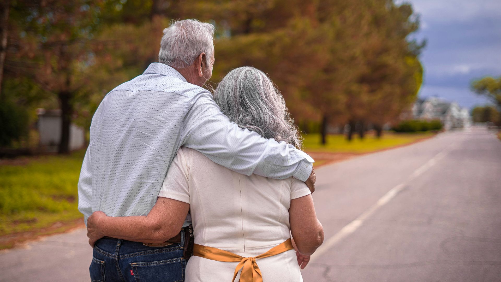 couple kissing on the road during daytime