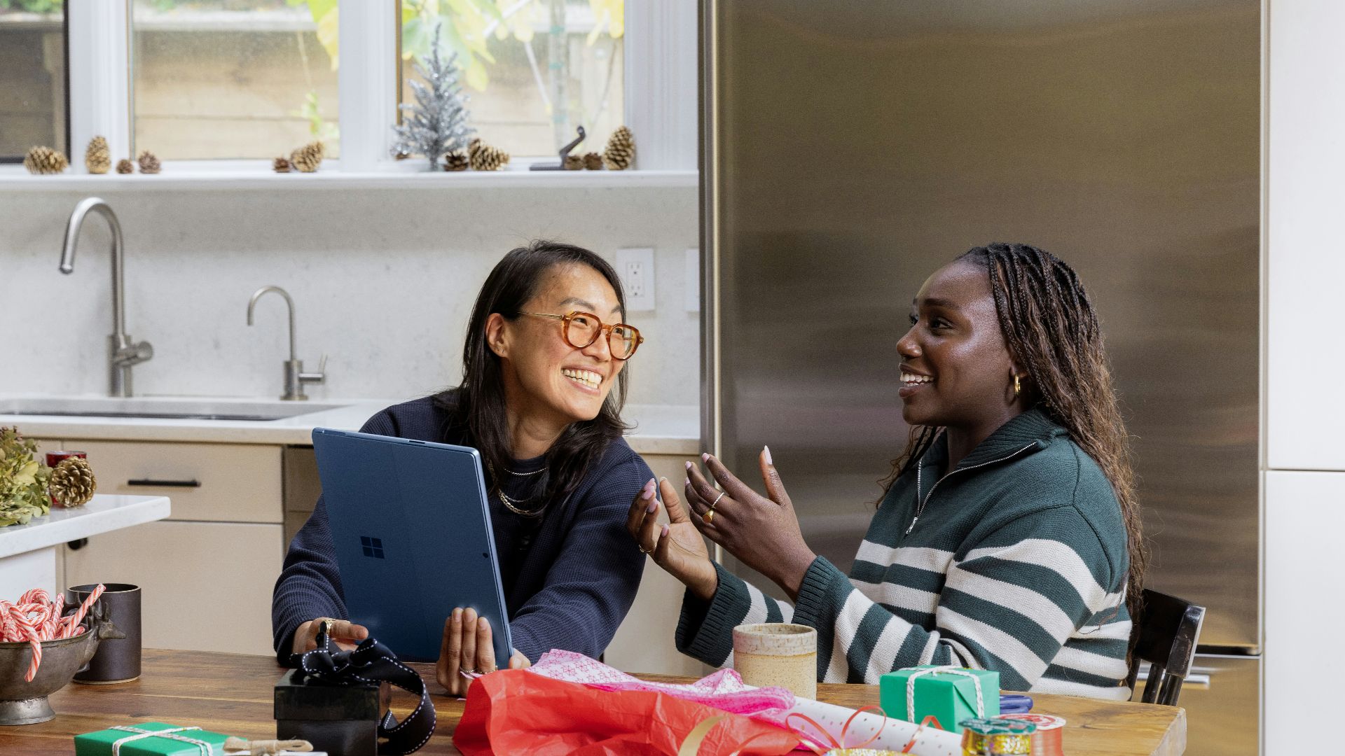 a woman sitting at a table in front of a window