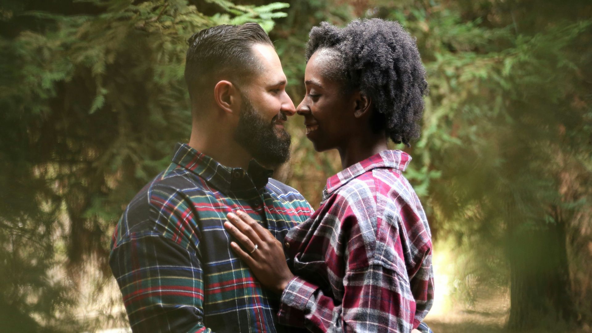 man and woman wearing button-up sports shirt on the center of trees