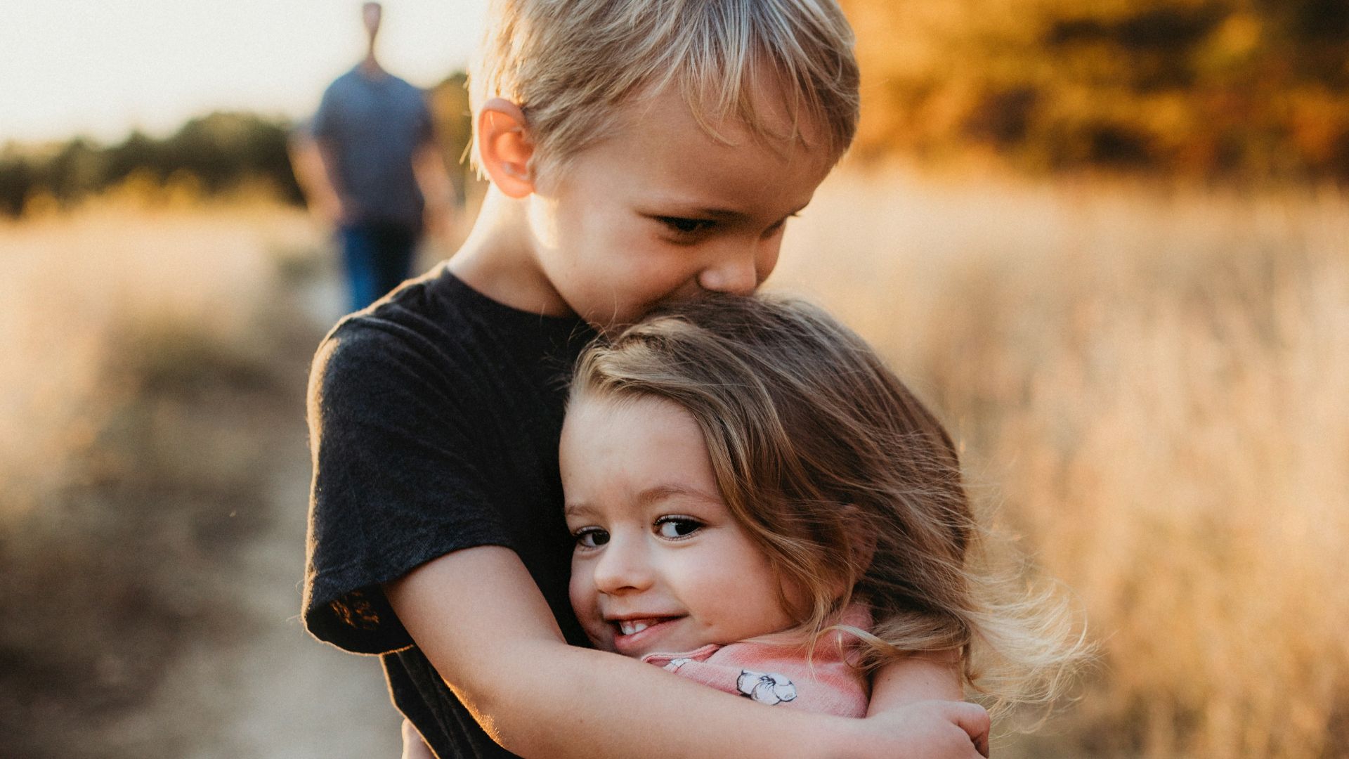 boy in black t-shirt hugging girl in red and white polka dot dress