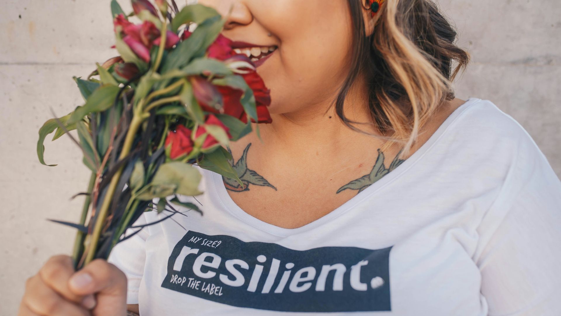 woman smelling red roses