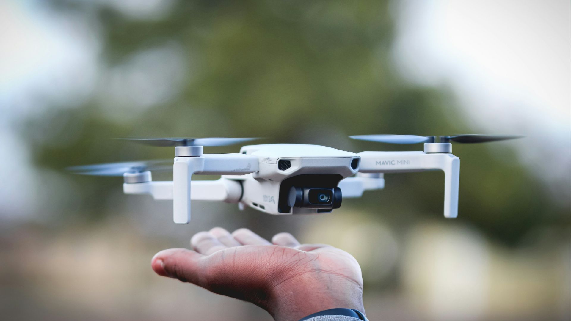 person holding white and black drone