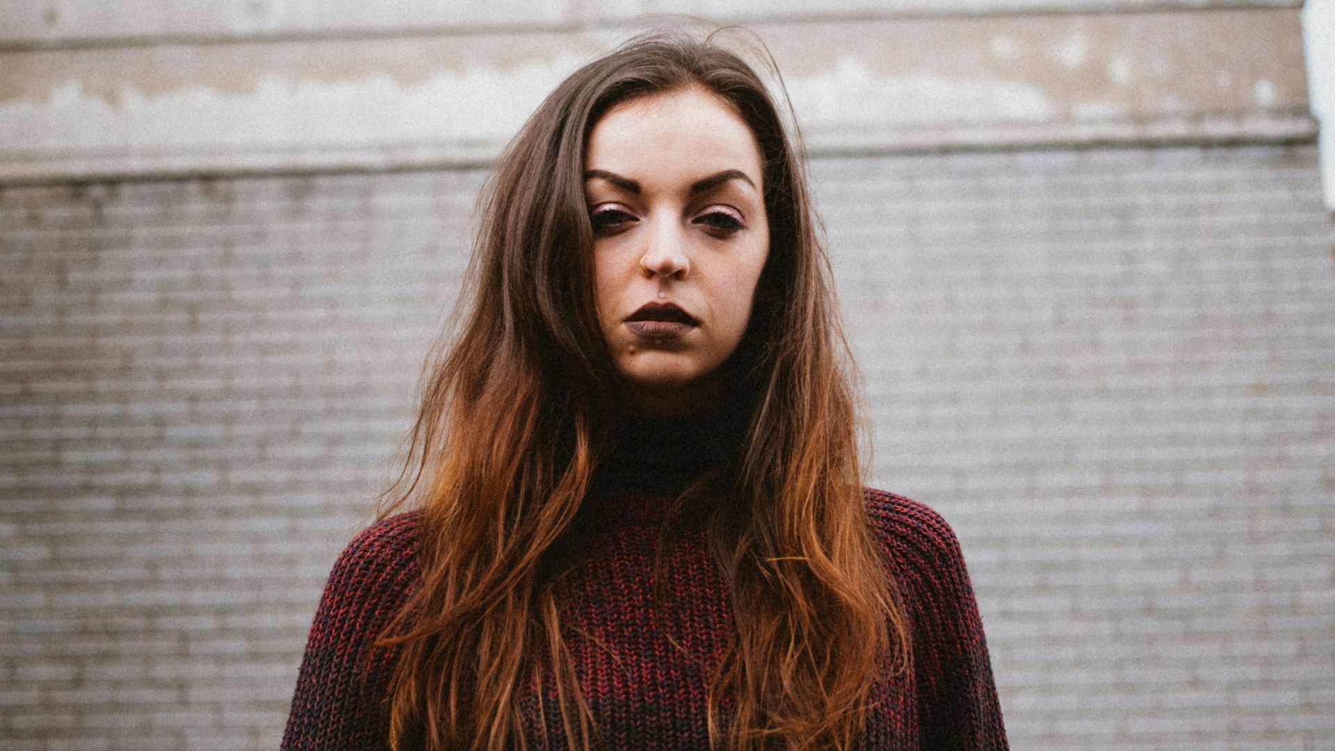 woman standing near brown building