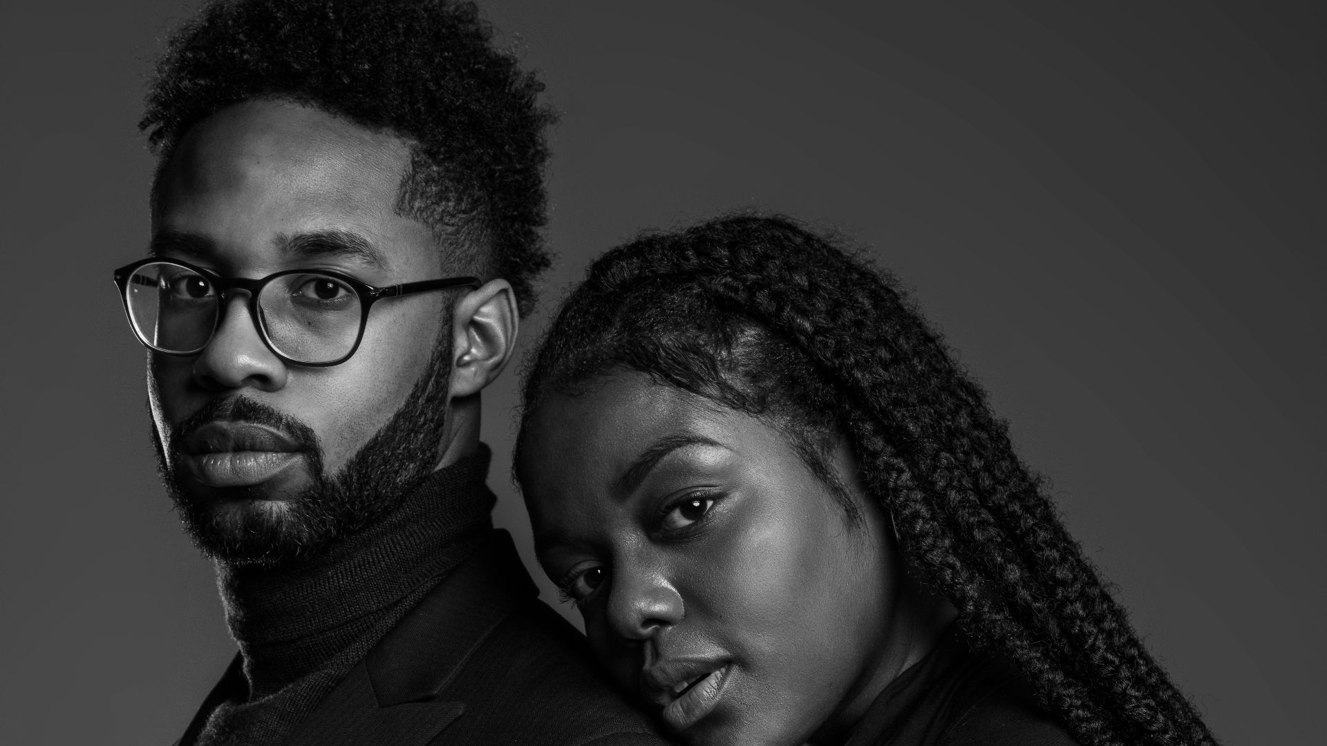 grayscale photo of man and woman posing