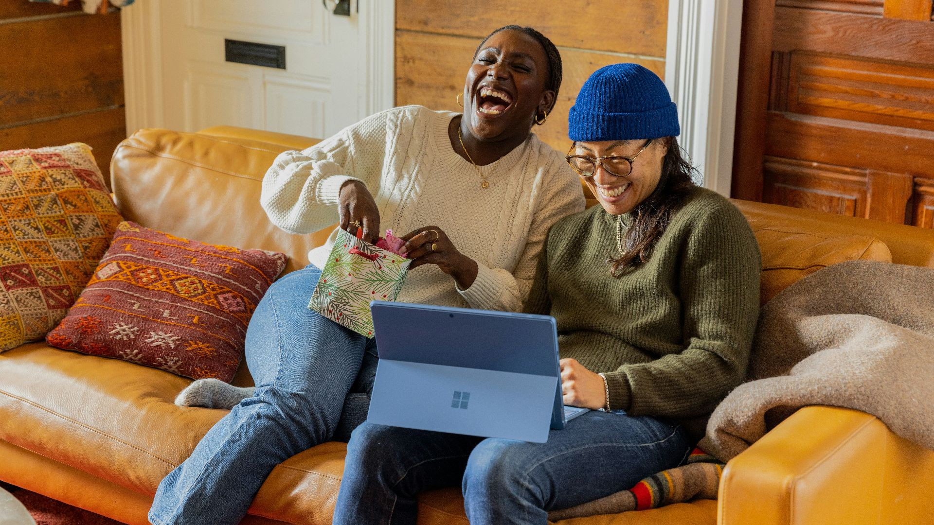a person sitting on a couch with a laptop