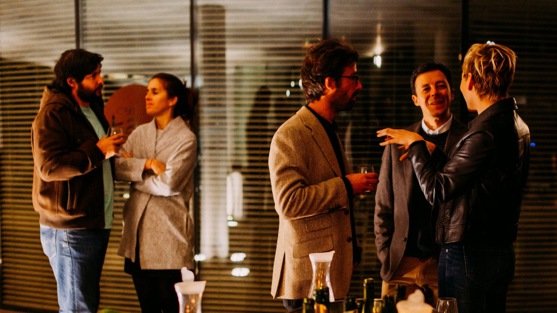 five person standing while talking each other
