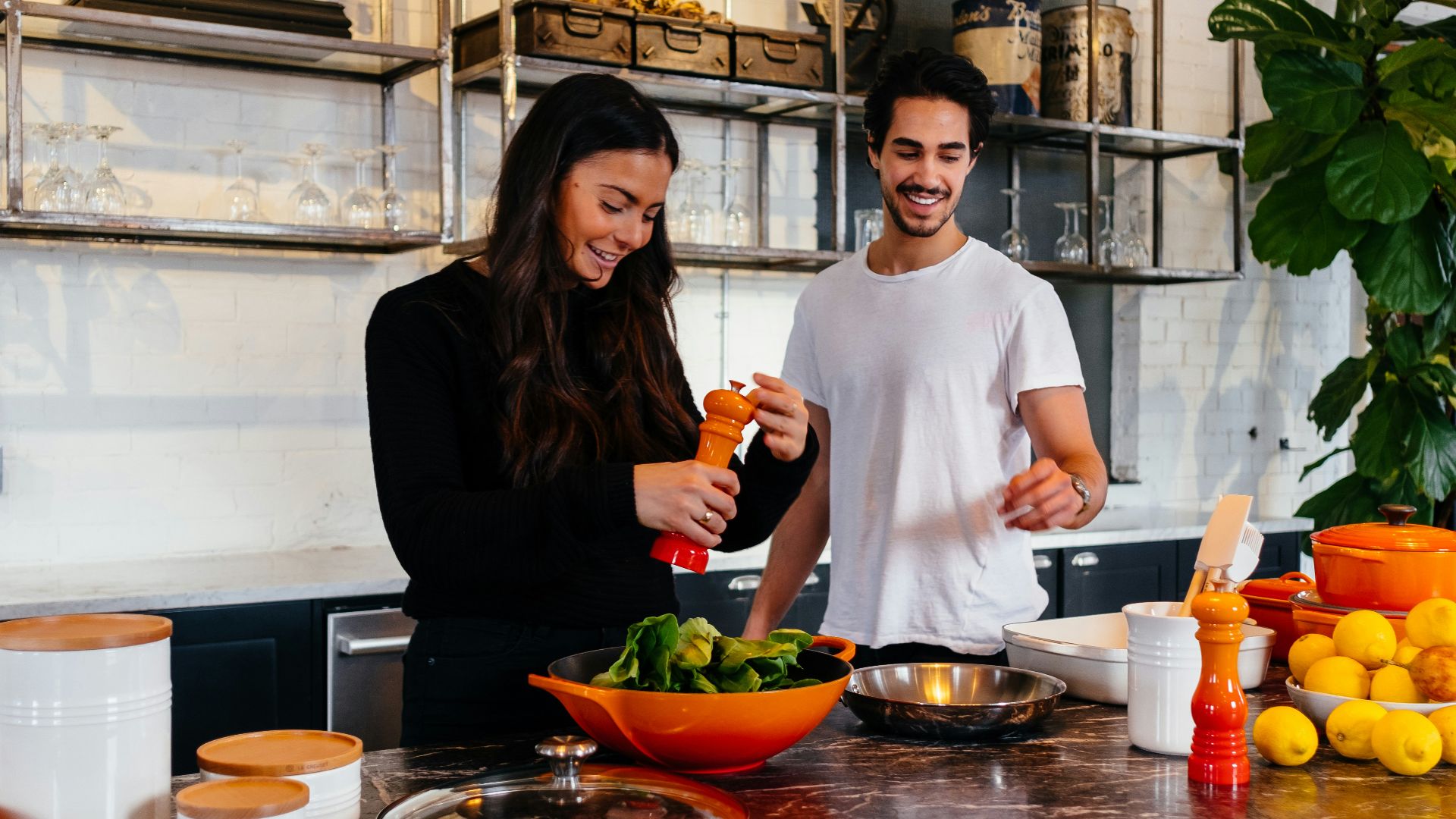 man and woman standing in front of table