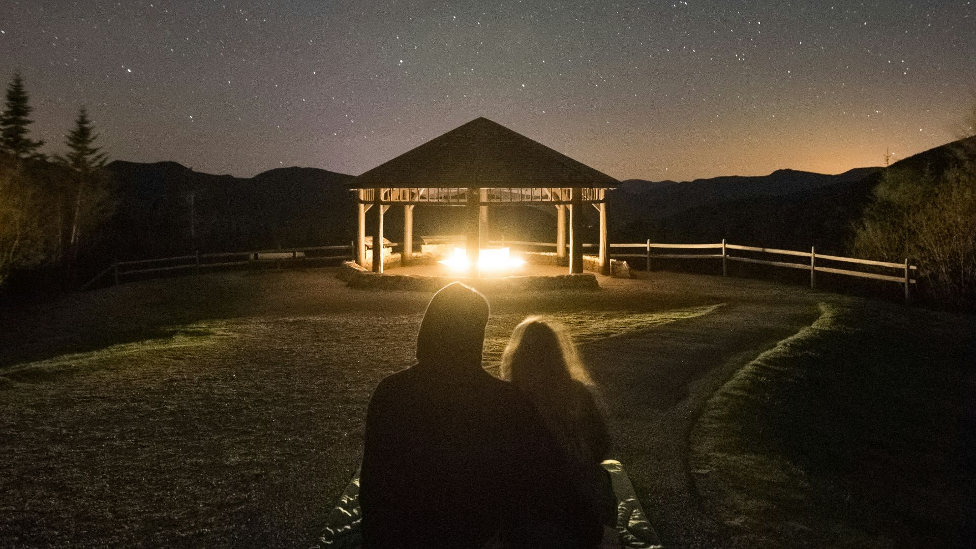silhouette photography of couple on grass field