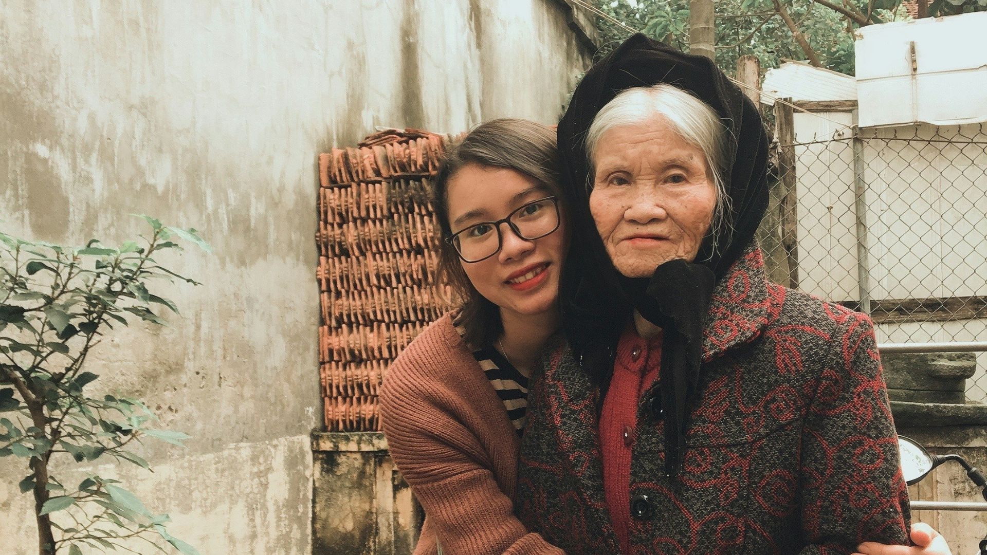 woman in red and brown long sleeve dress sitting on brown wicker chair