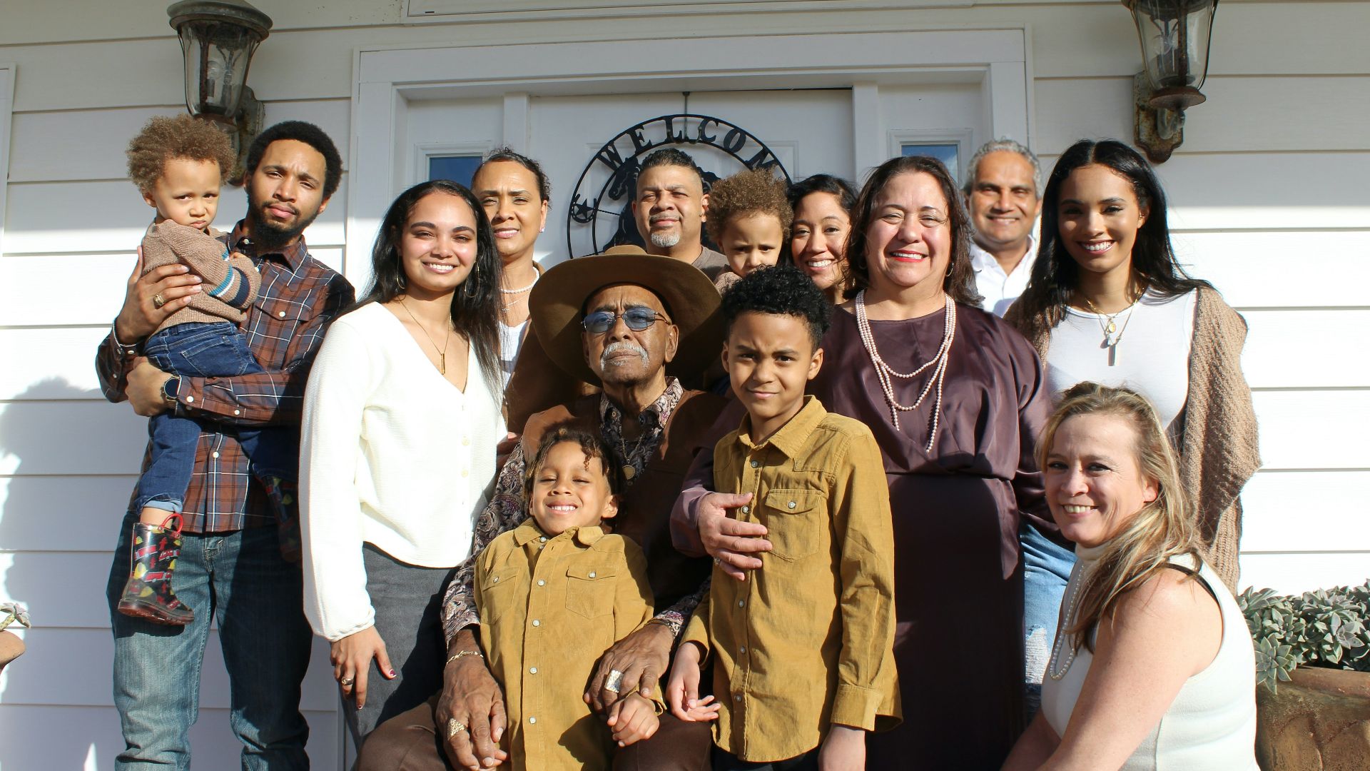 group of people standing near white building