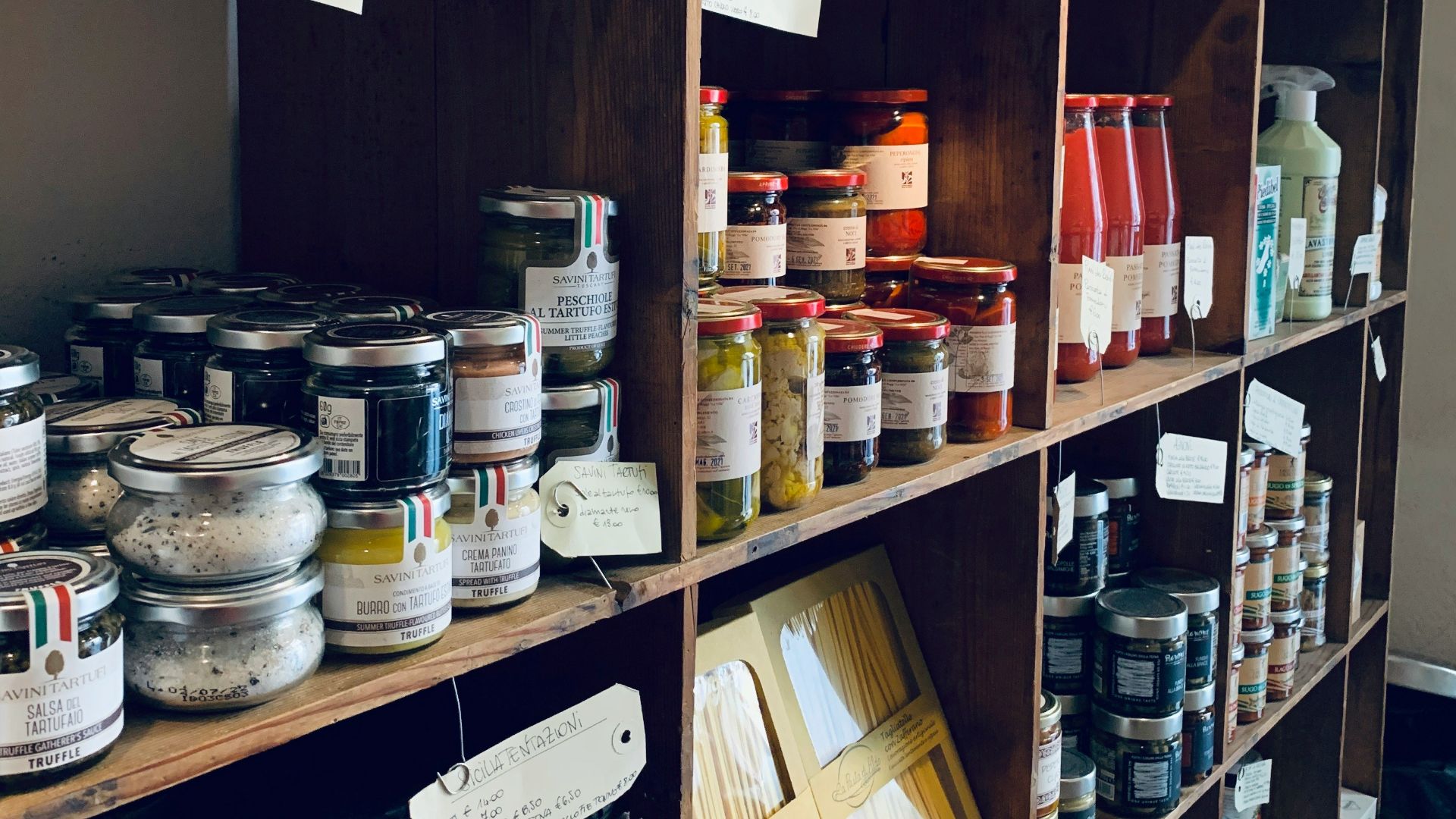 assorted glass jars on brown wooden shelf