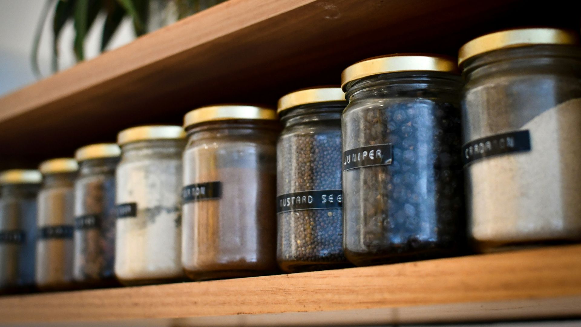 a shelf filled with lots of different types of spices