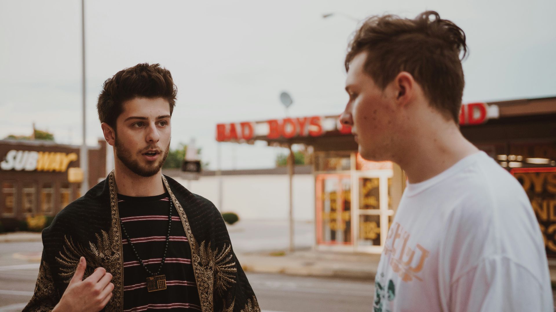 man talking to another man