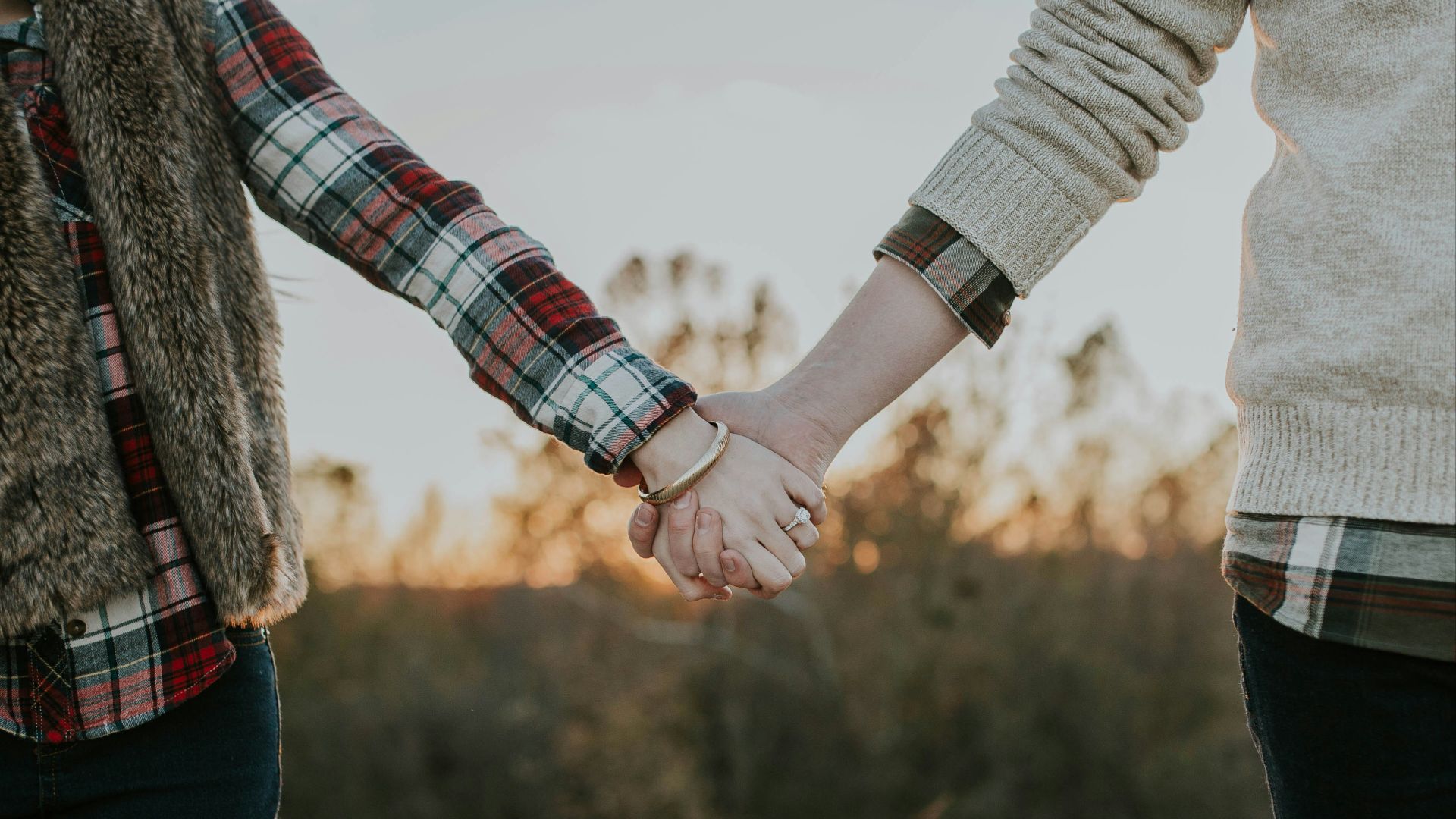 two person holding hands while standing