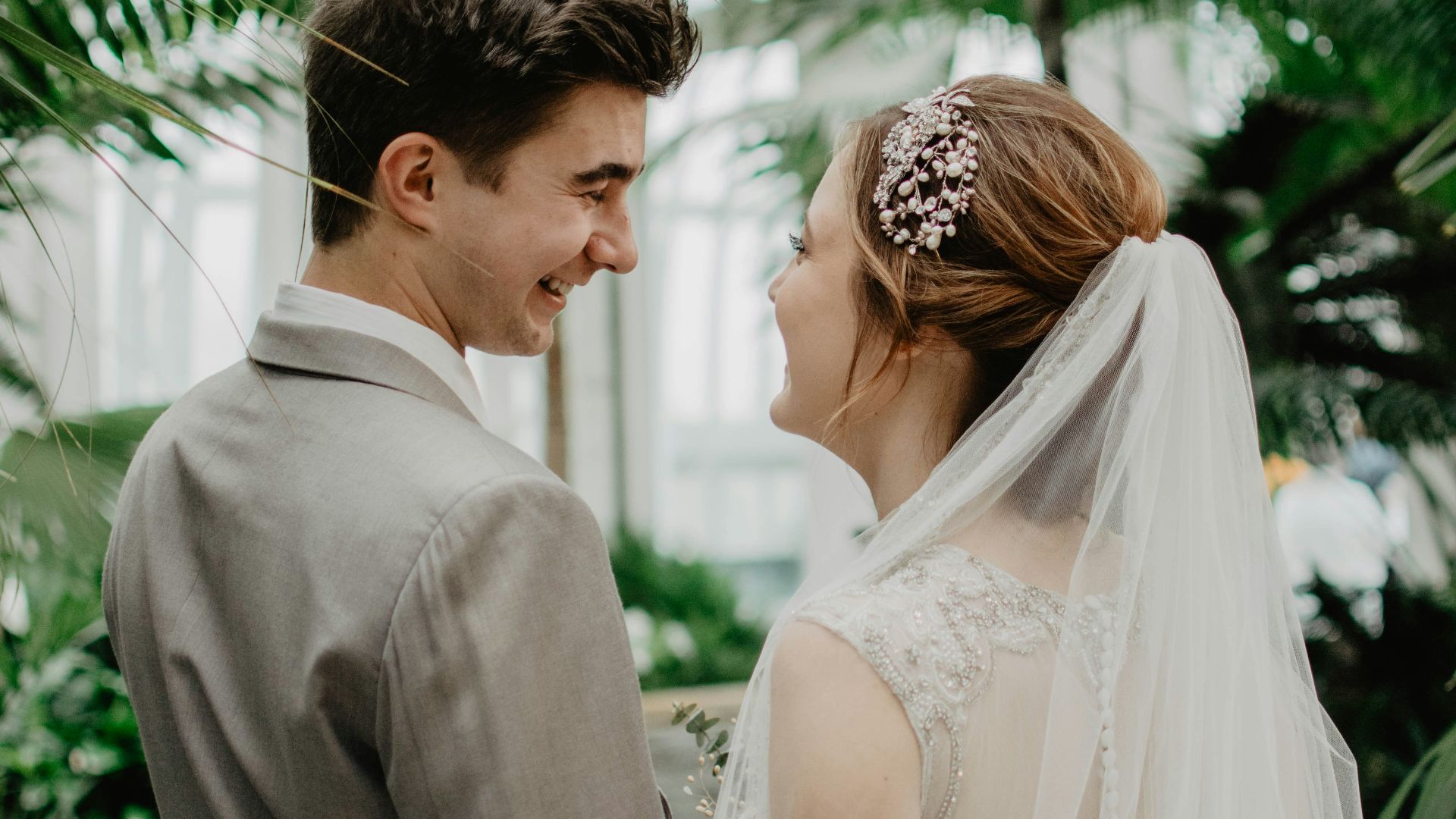 bride and groom surrounded by plants