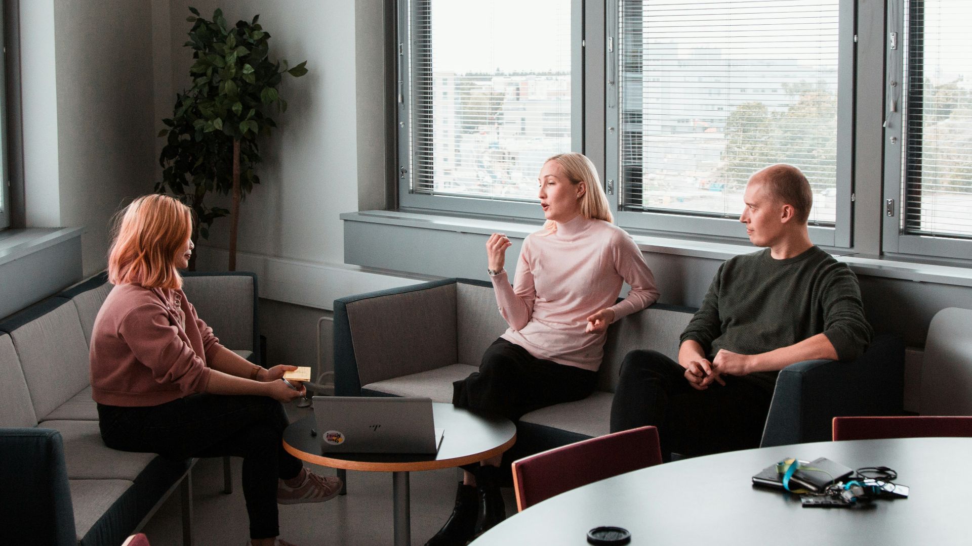 2 women sitting on black sofa
