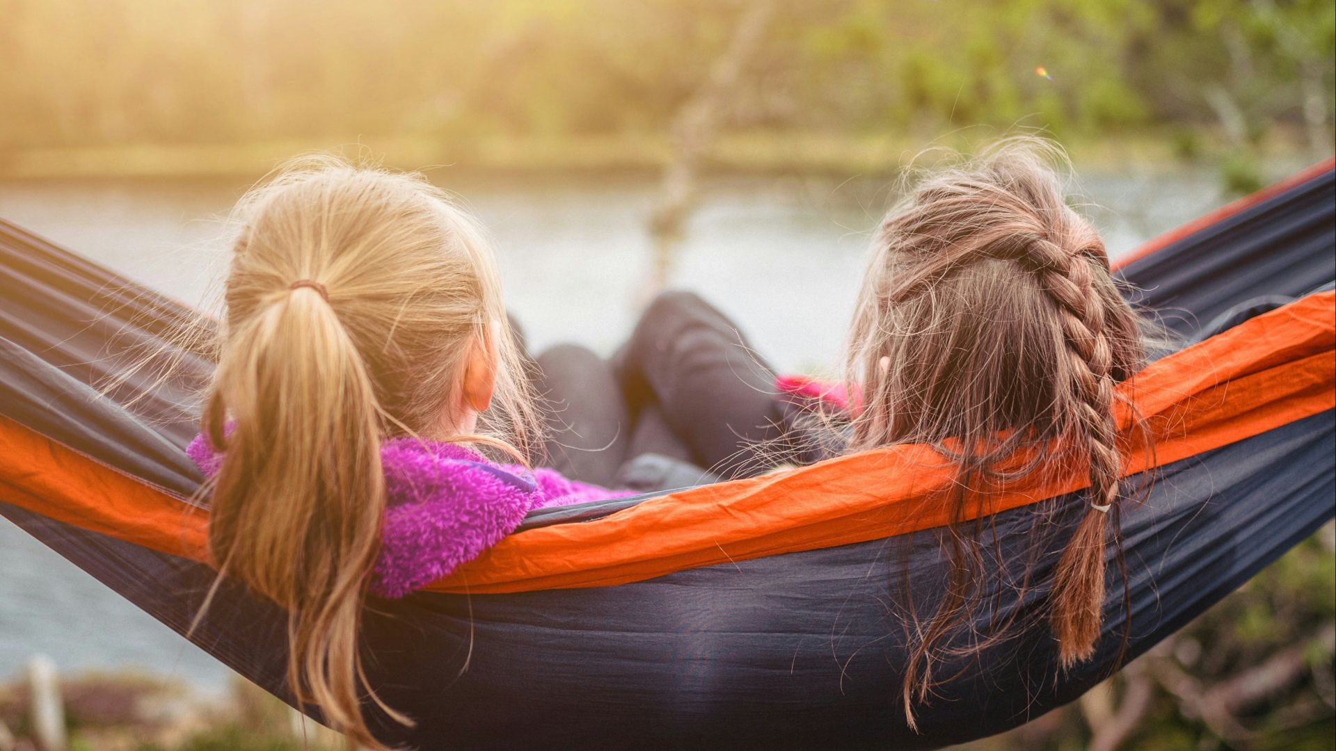 two women lying on hammock
