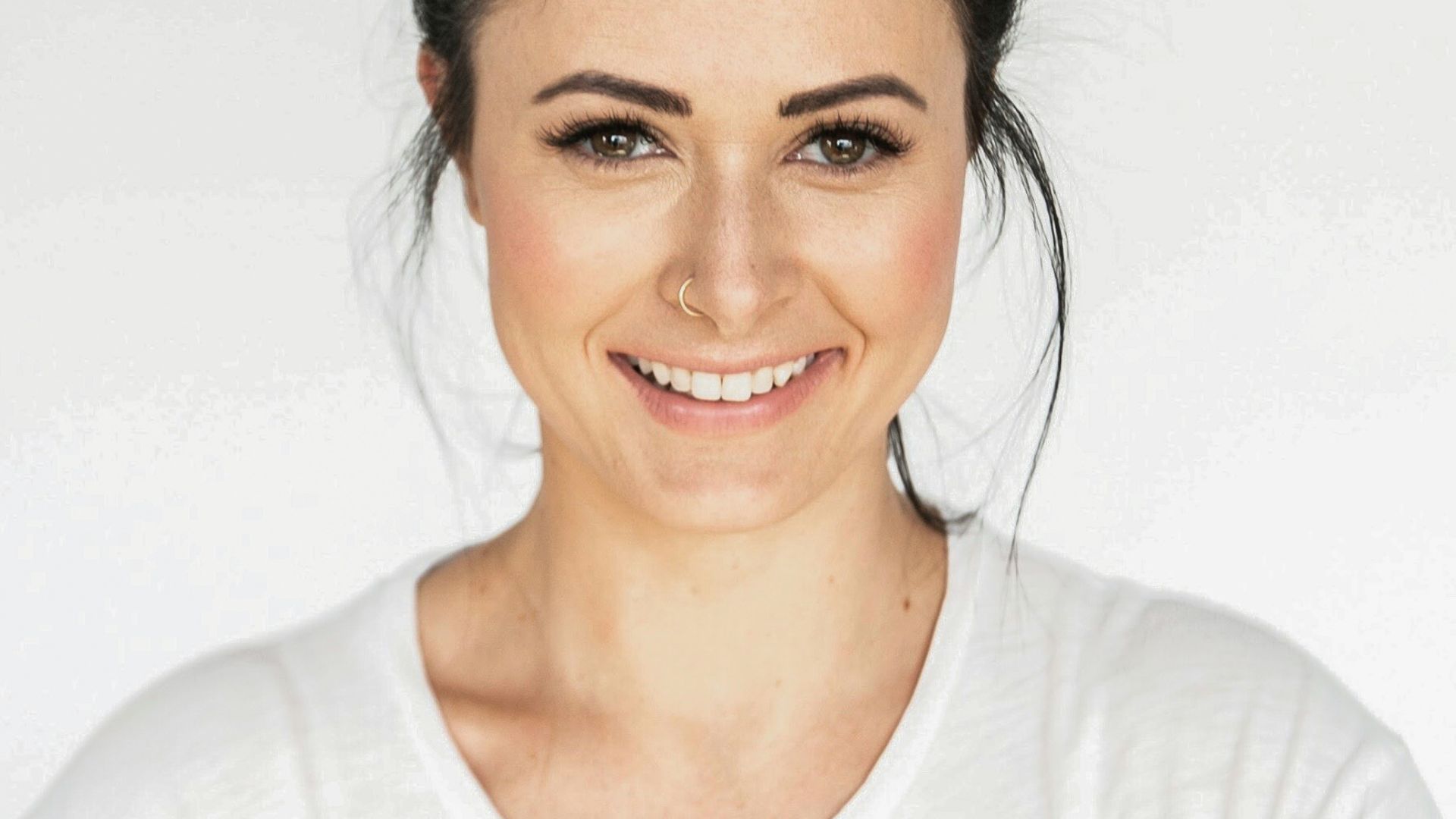 woman in white crew neck shirt smiling